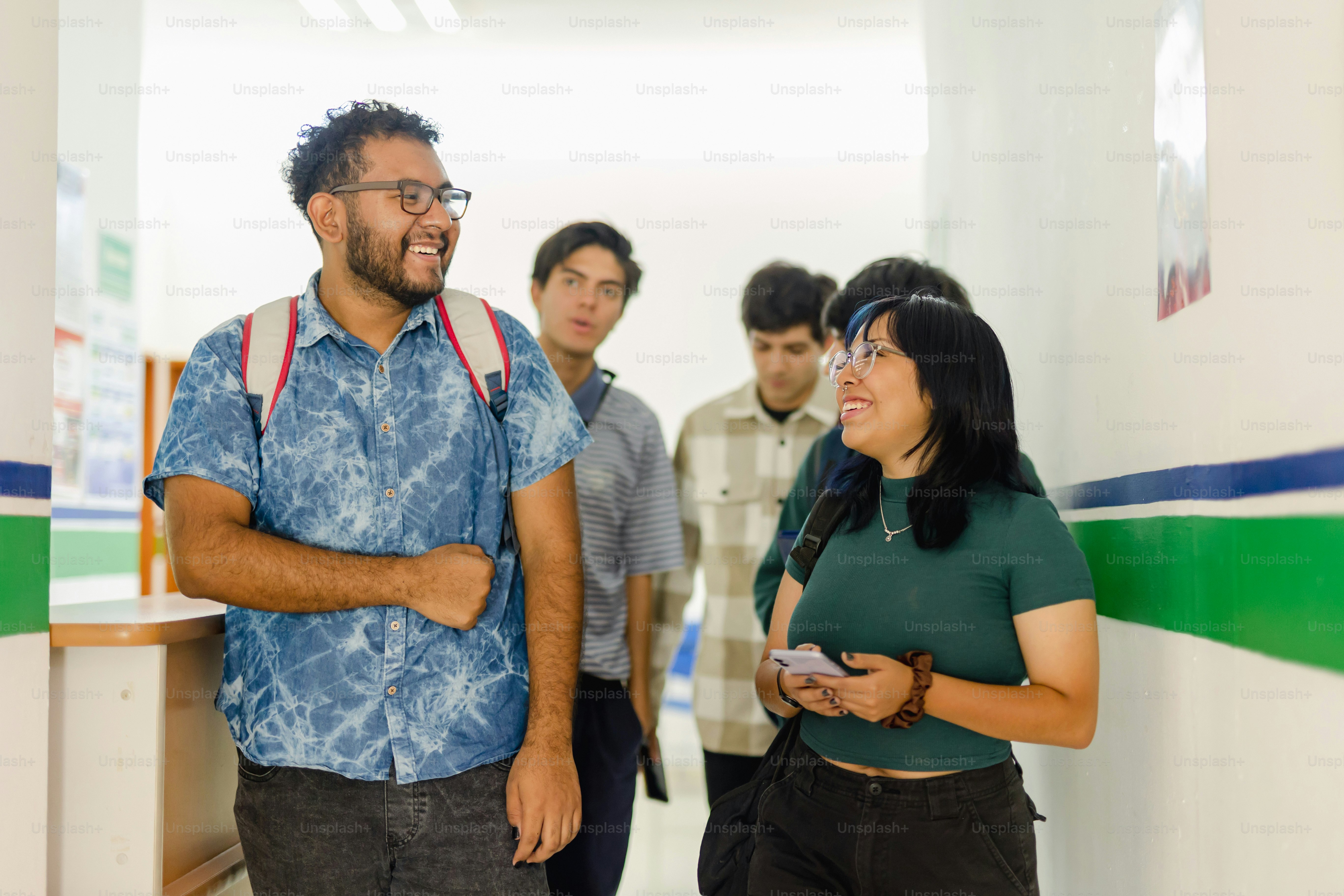 A group of people standing in a hallway photo – College Image on Unsplash