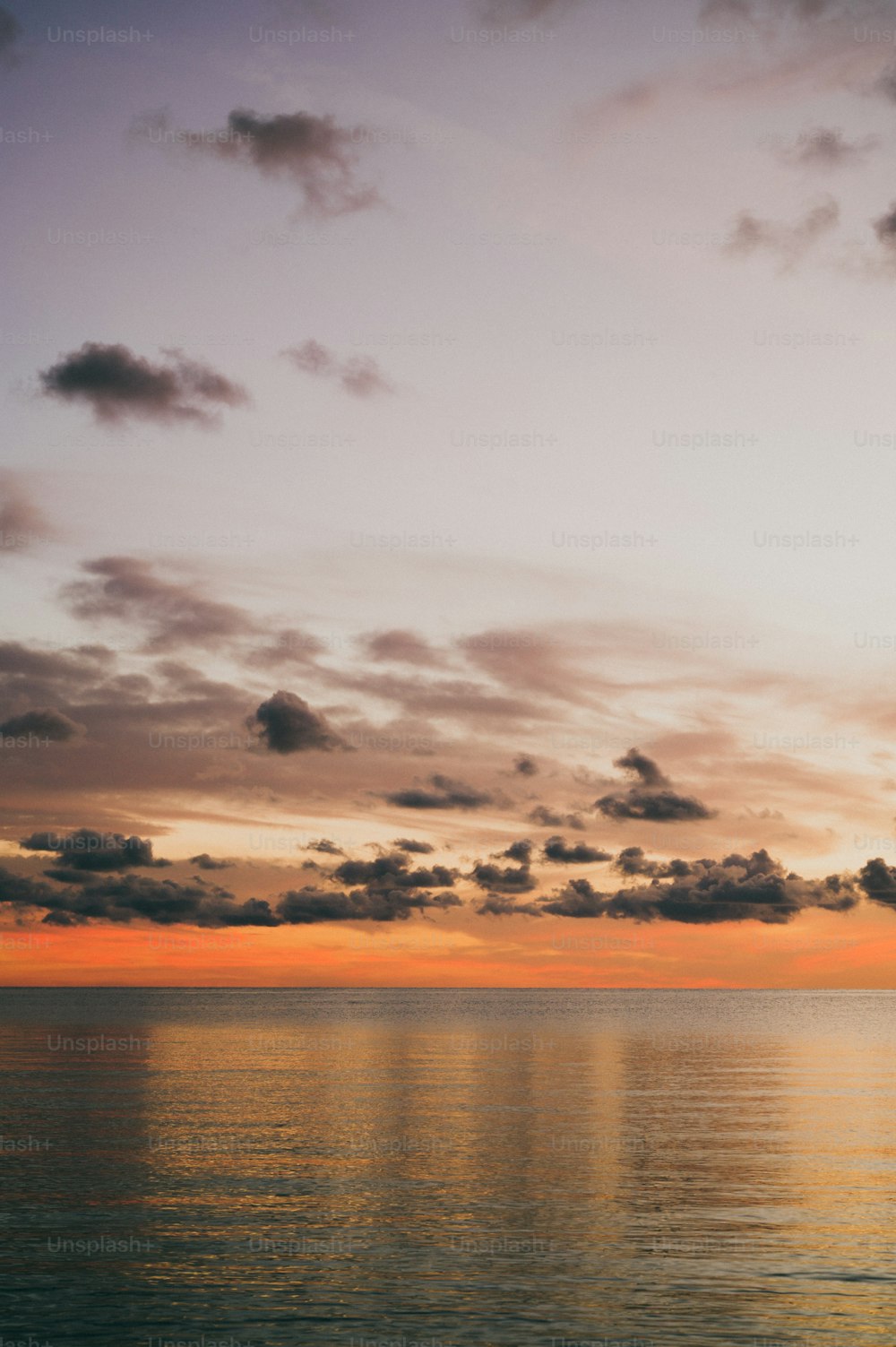 a large body of water under a cloudy sky