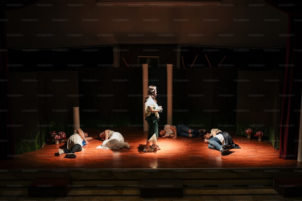 a group of people laying on a stage