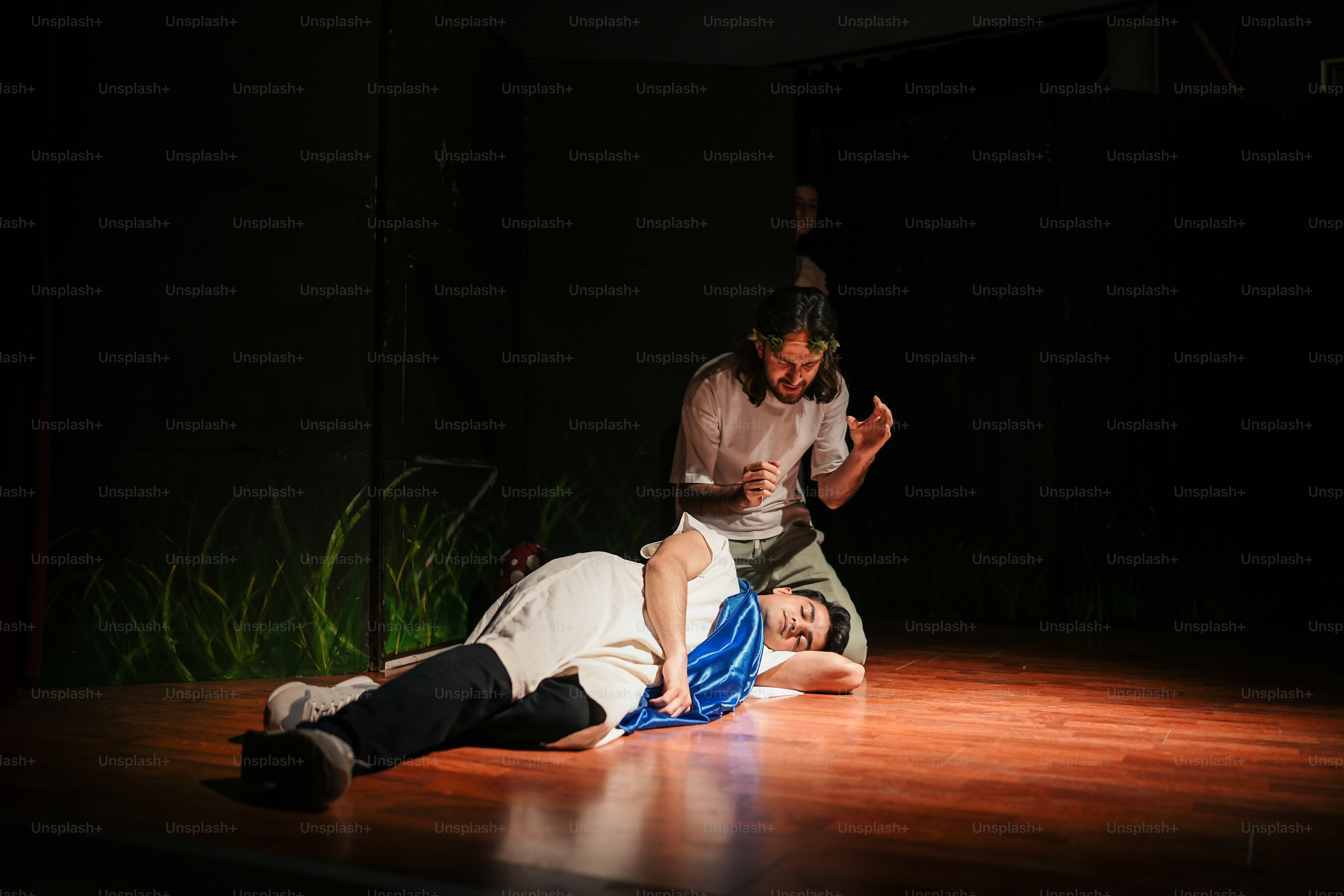 a man laying on the ground next to another man