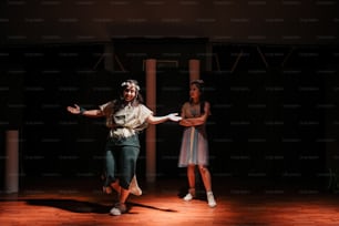 a couple of people standing on top of a wooden floor