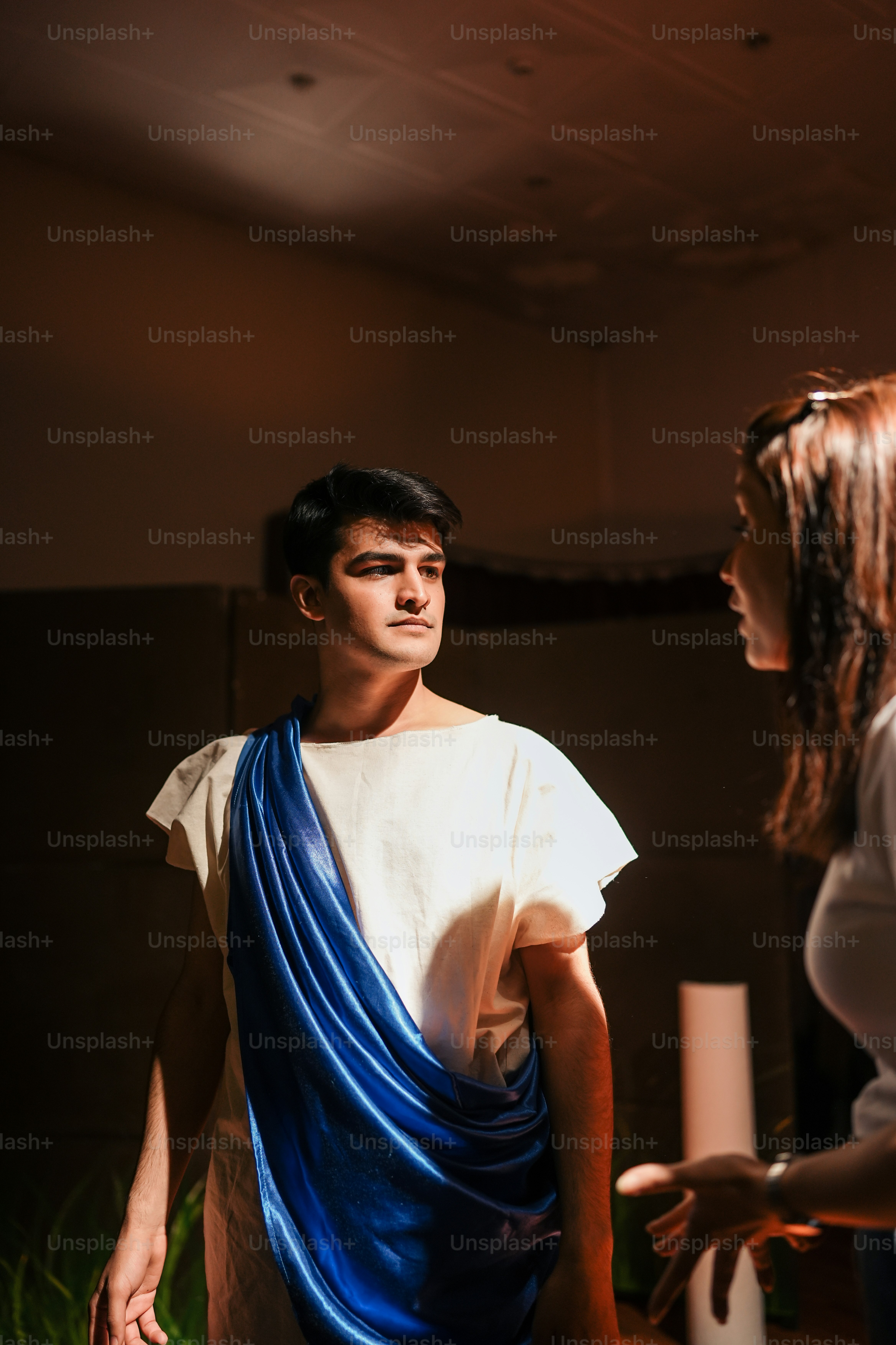 a woman standing next to a man in a white shirt