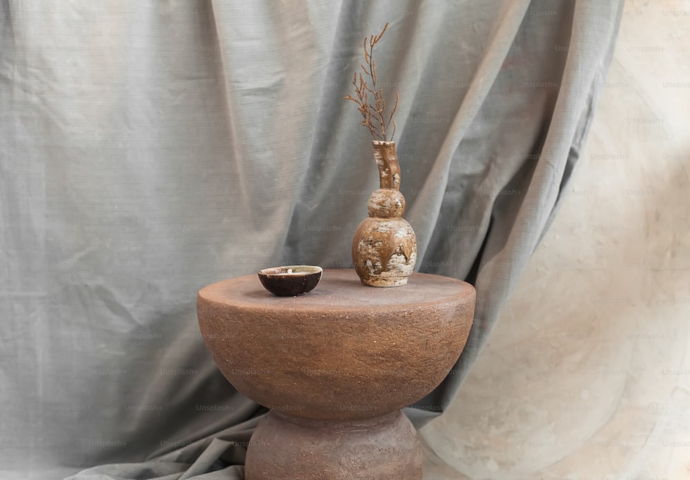 a table with a vase and a bowl on it