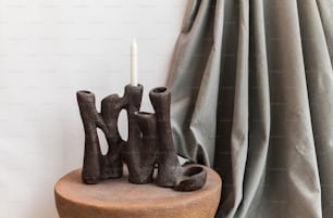 a candle is sitting on a small table