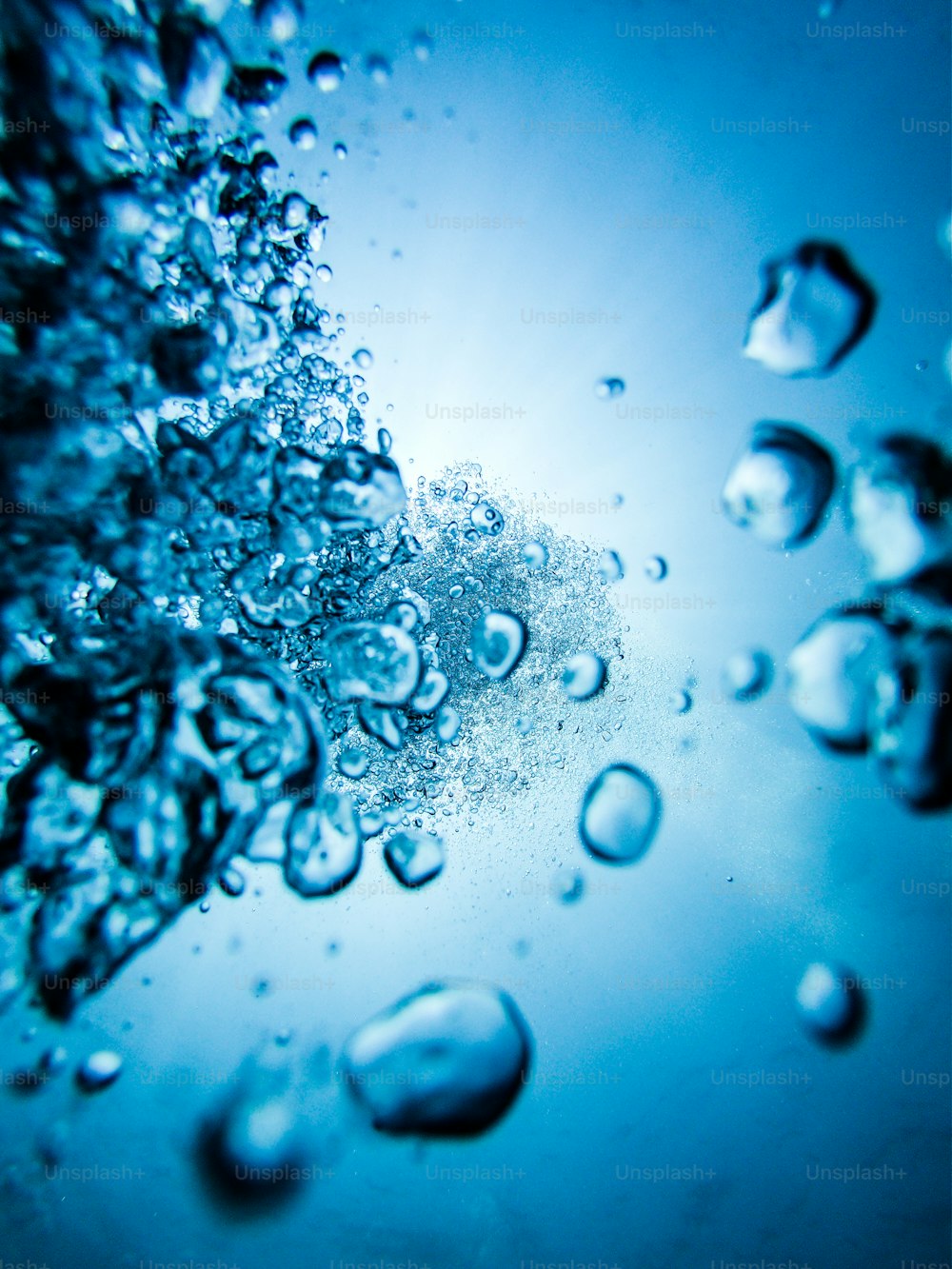 a close up of water bubbles on a blue surface