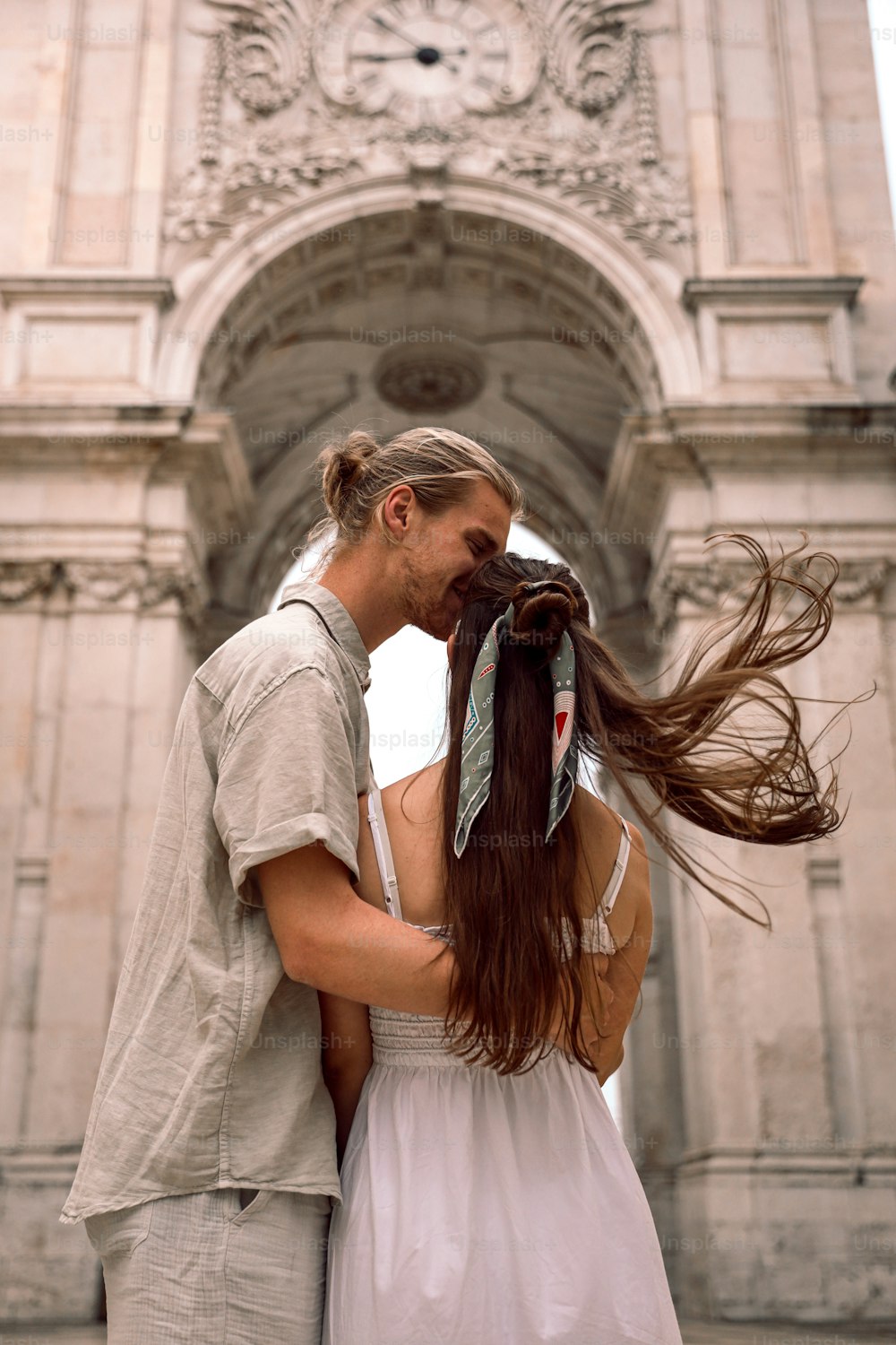 a man and a woman standing in front of a building