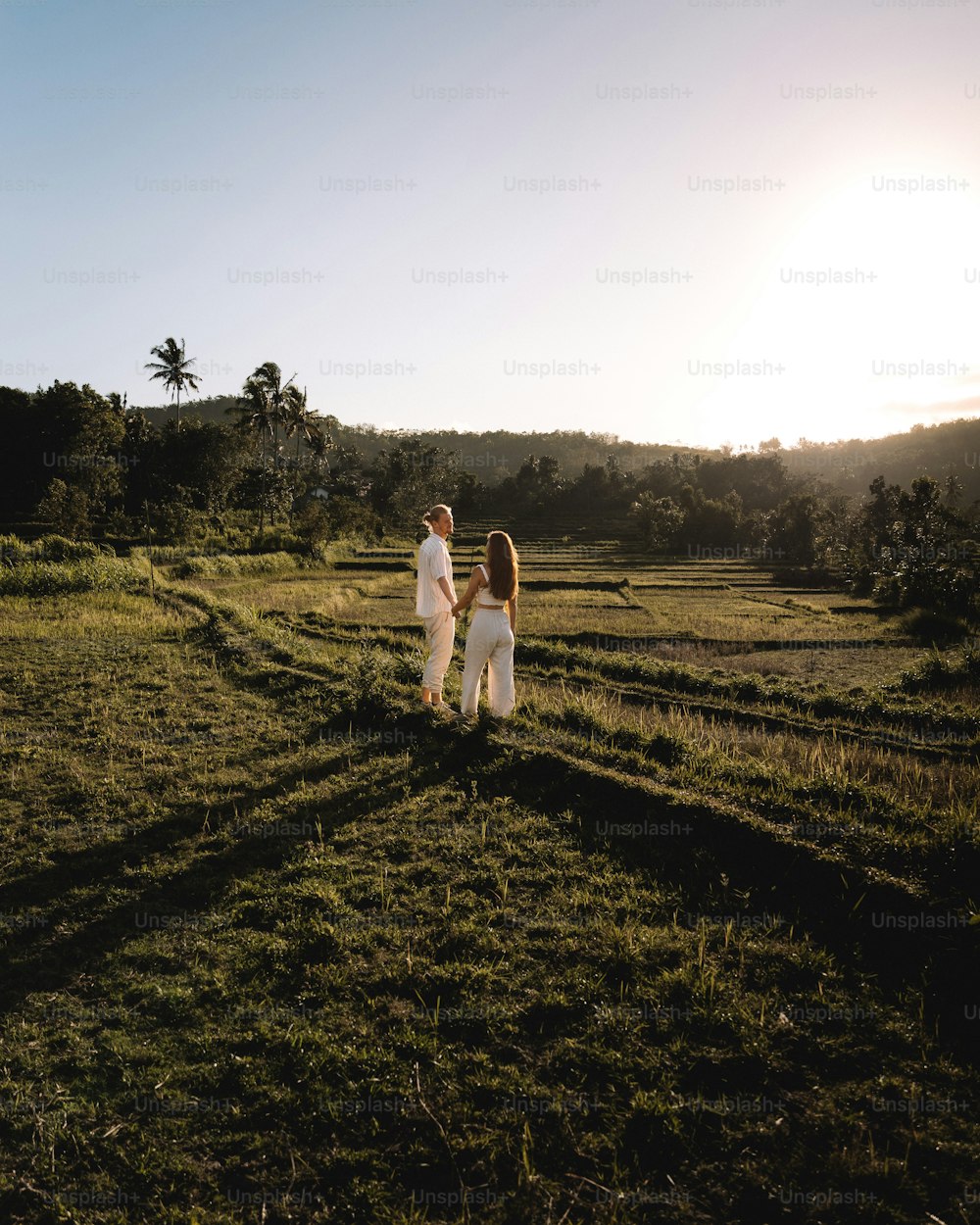 a couple of people standing in a field