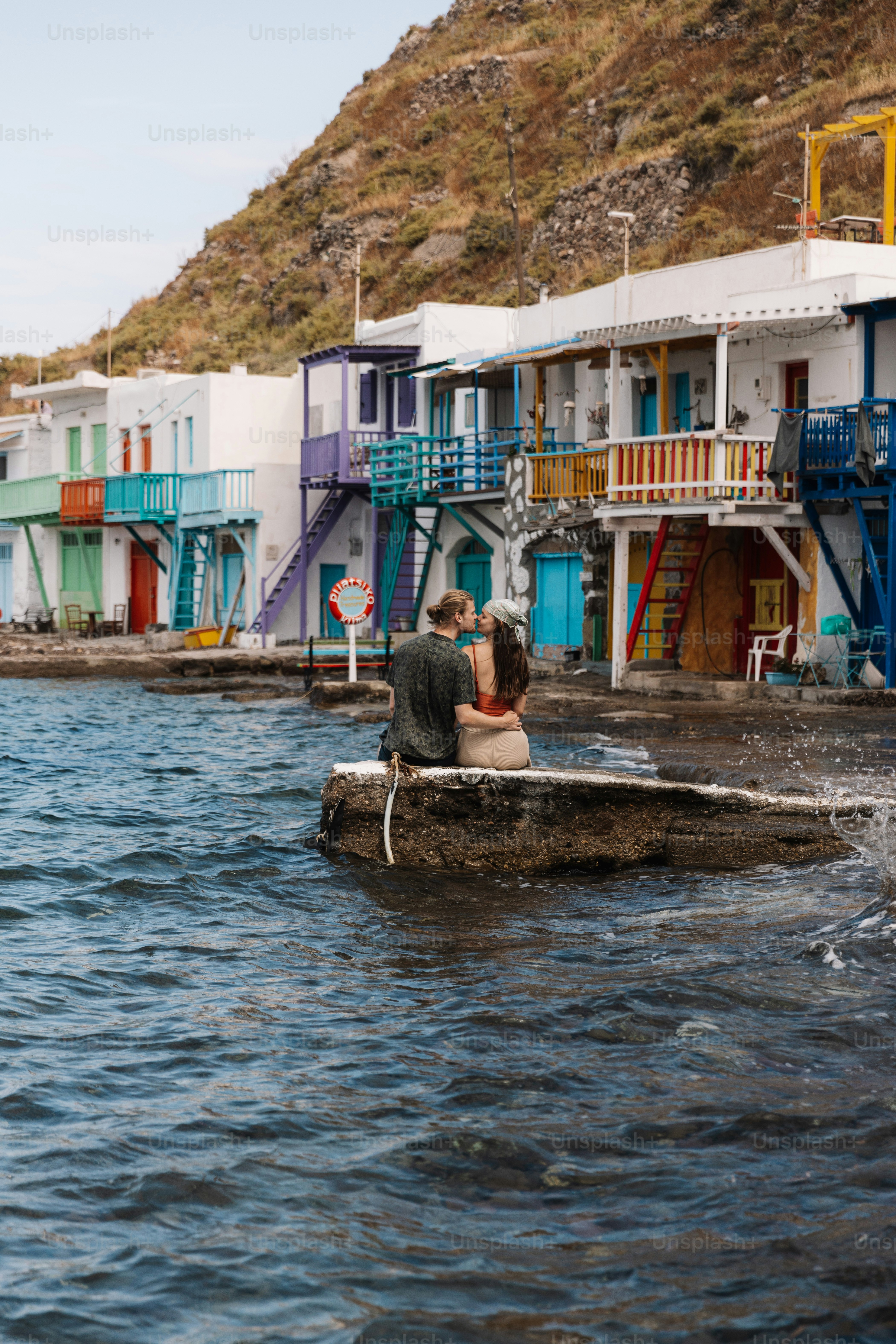 a man and a woman in a small boat in the water
