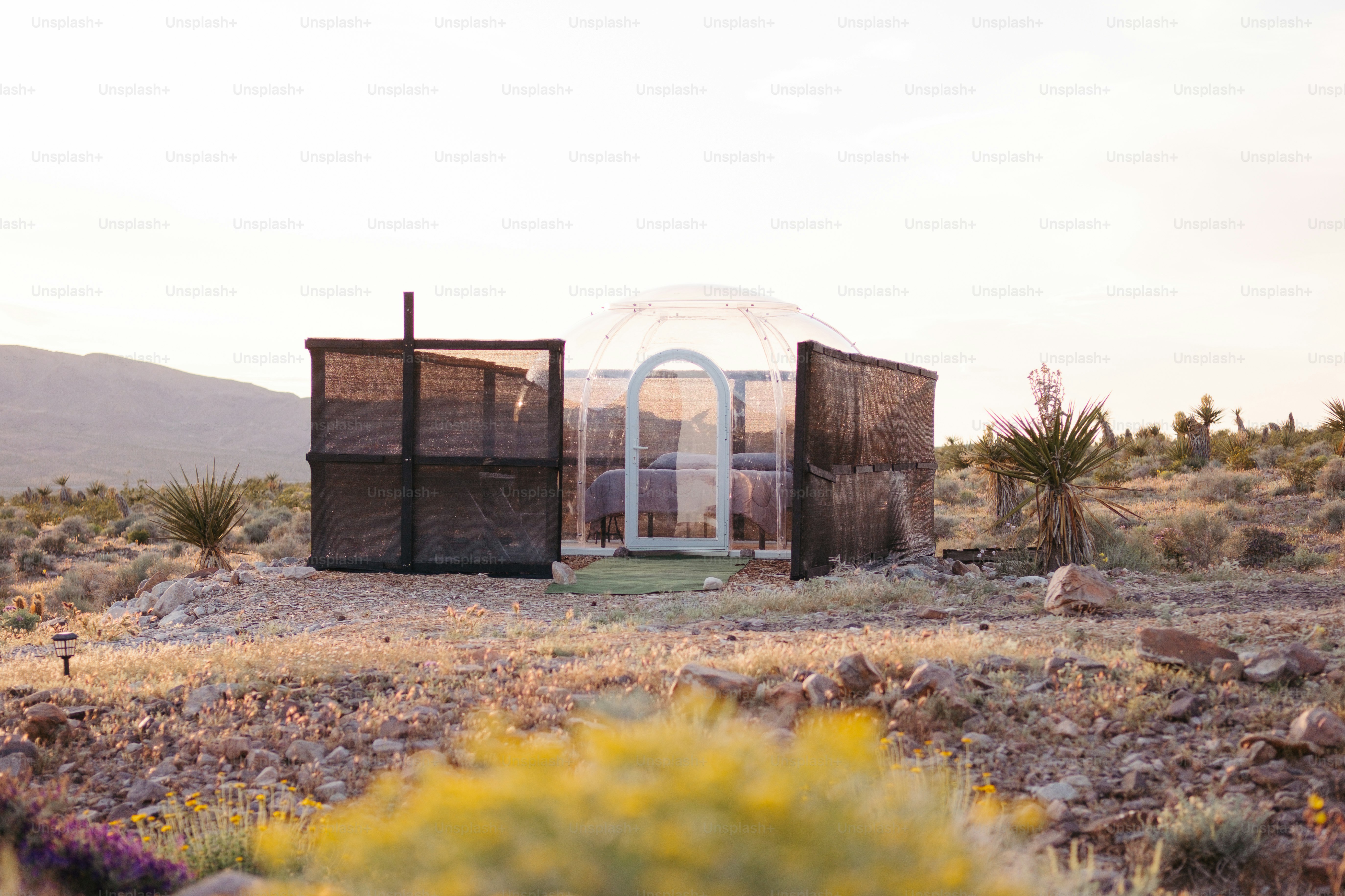 a small building in the middle of a desert