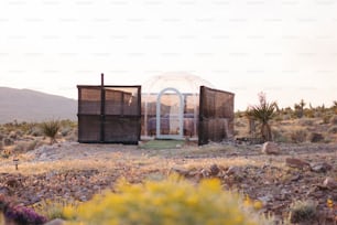 a small building in the middle of a desert