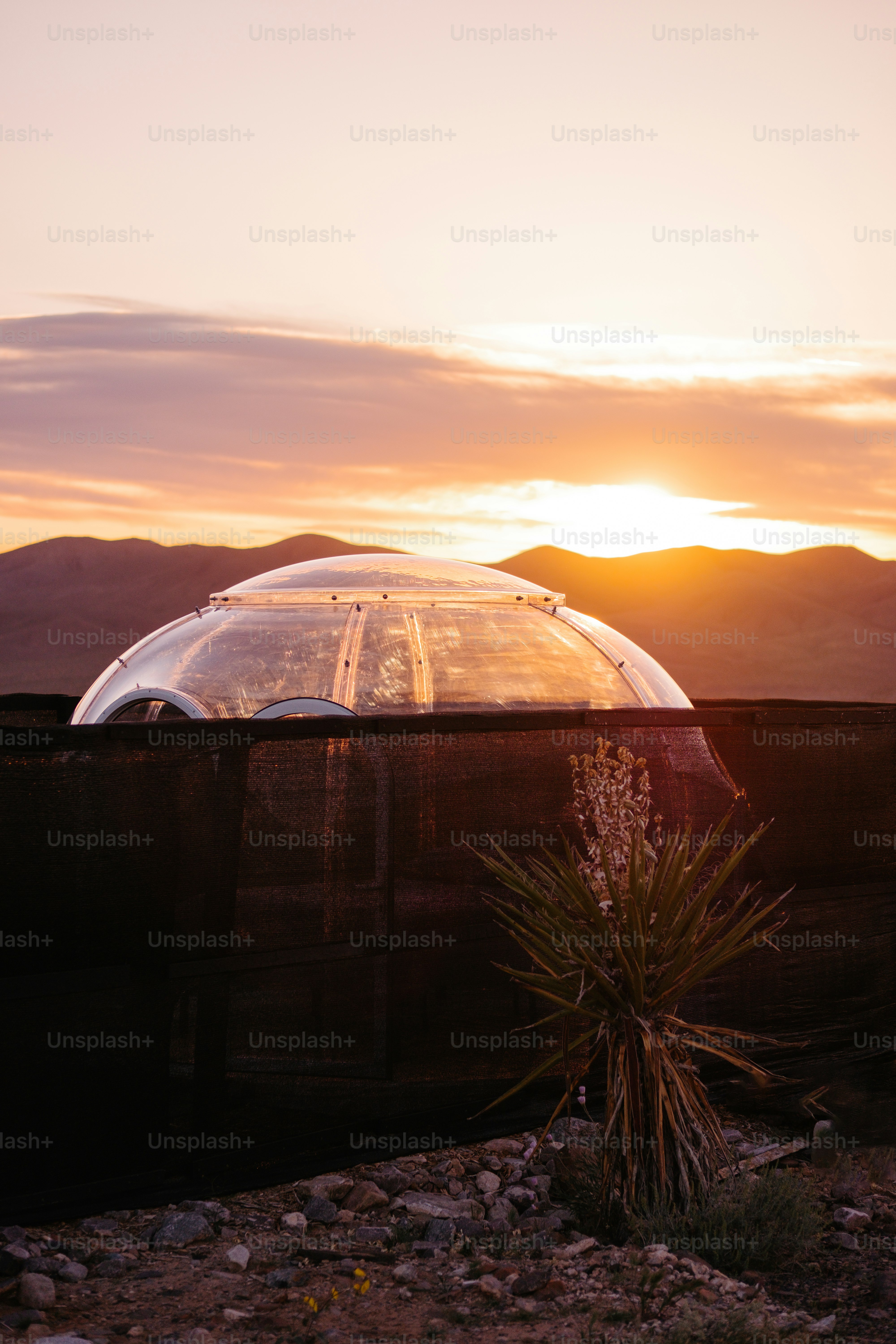 the sun is setting behind a dome structure