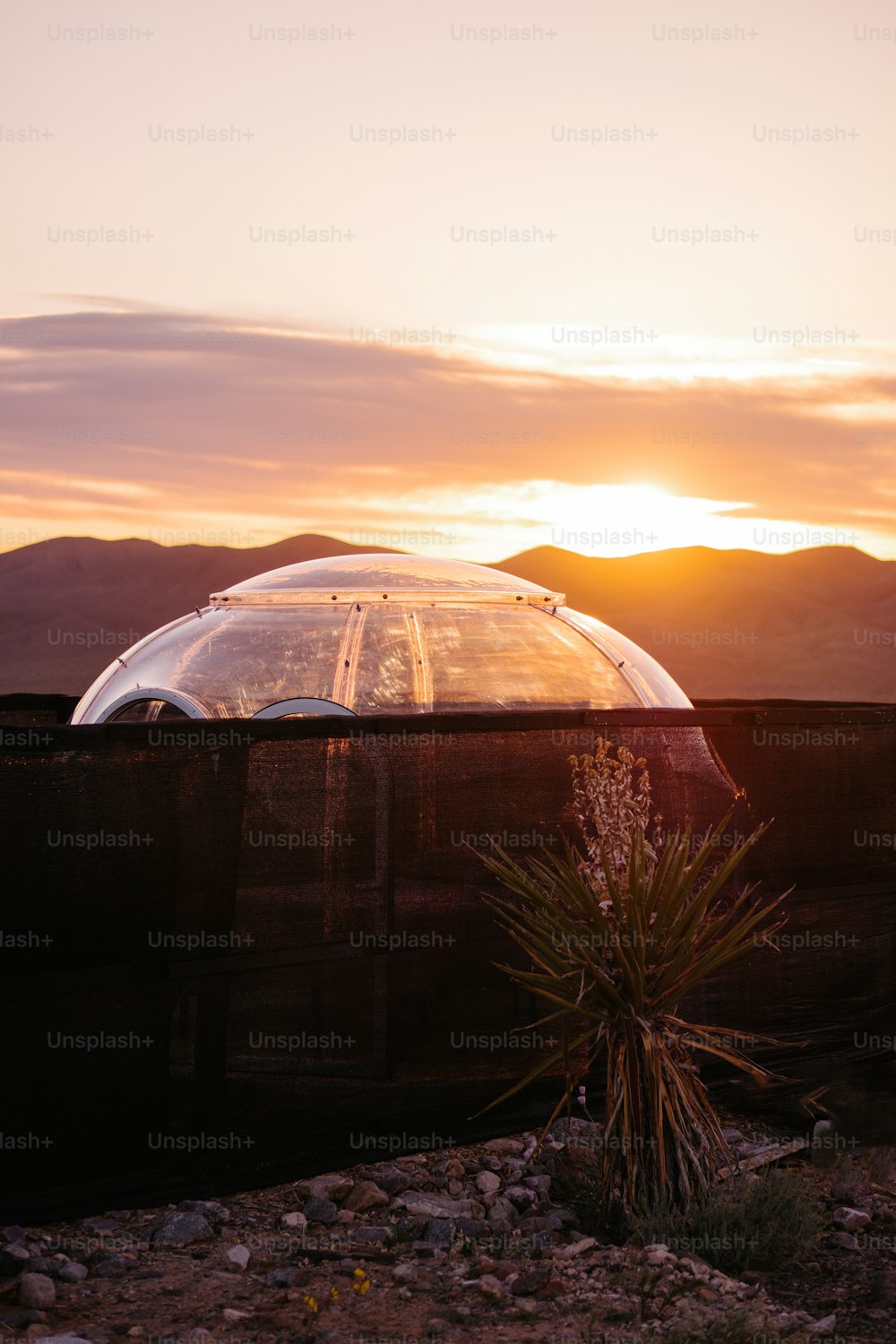 the sun is setting behind a dome structure