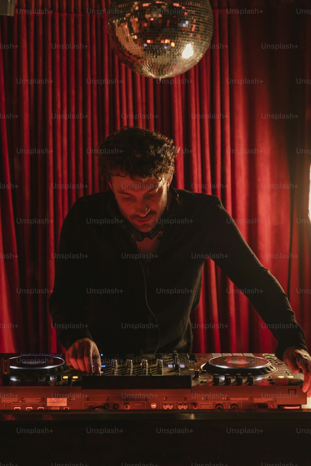 a man that is sitting at a dj's desk