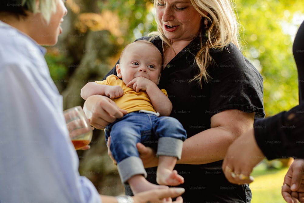 a woman holding a baby in her arms