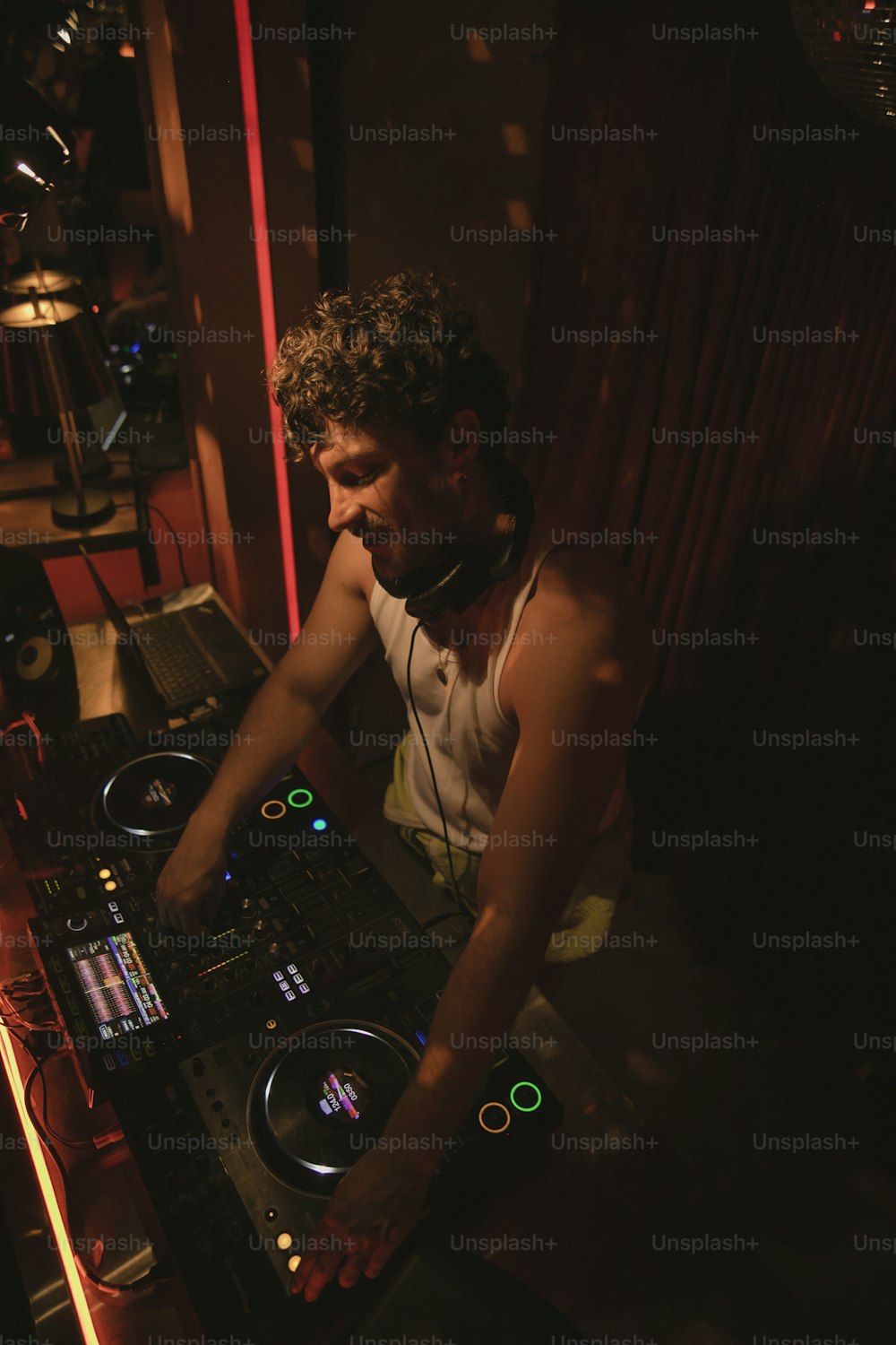 a man that is sitting at a dj's desk