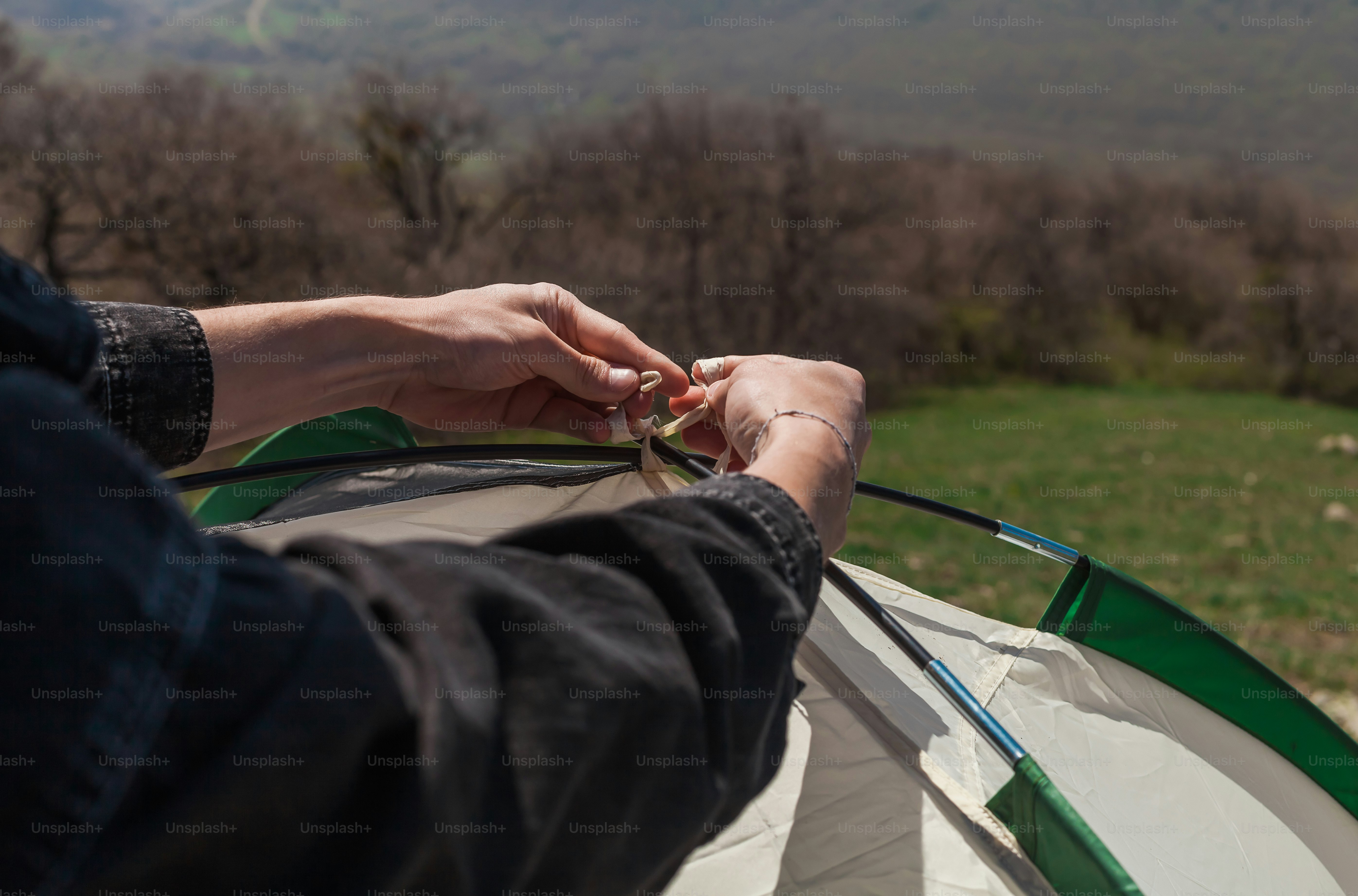 a person holding onto a kite in a field