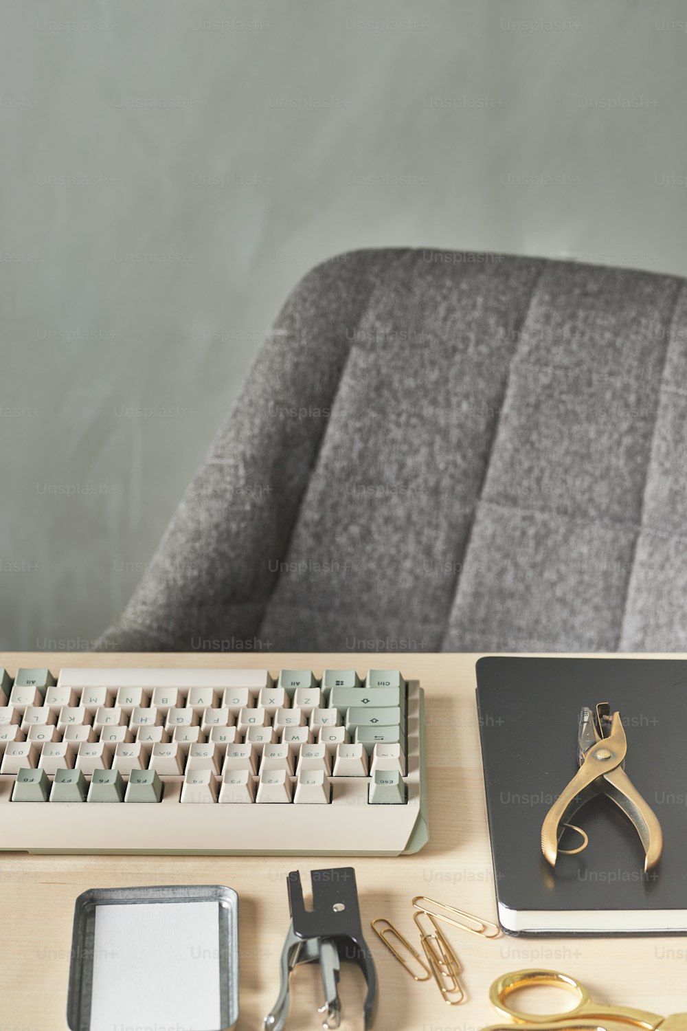 a computer keyboard sitting on top of a wooden desk