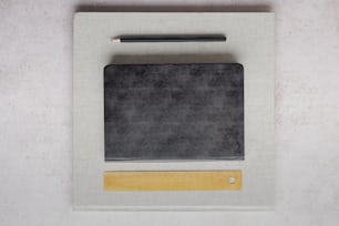 a black and white picture frame with a pencil on it
