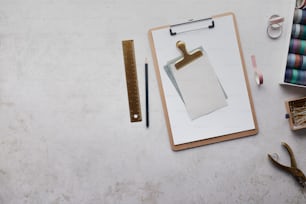 a clipboard with a piece of paper on it next to a pair of scissors