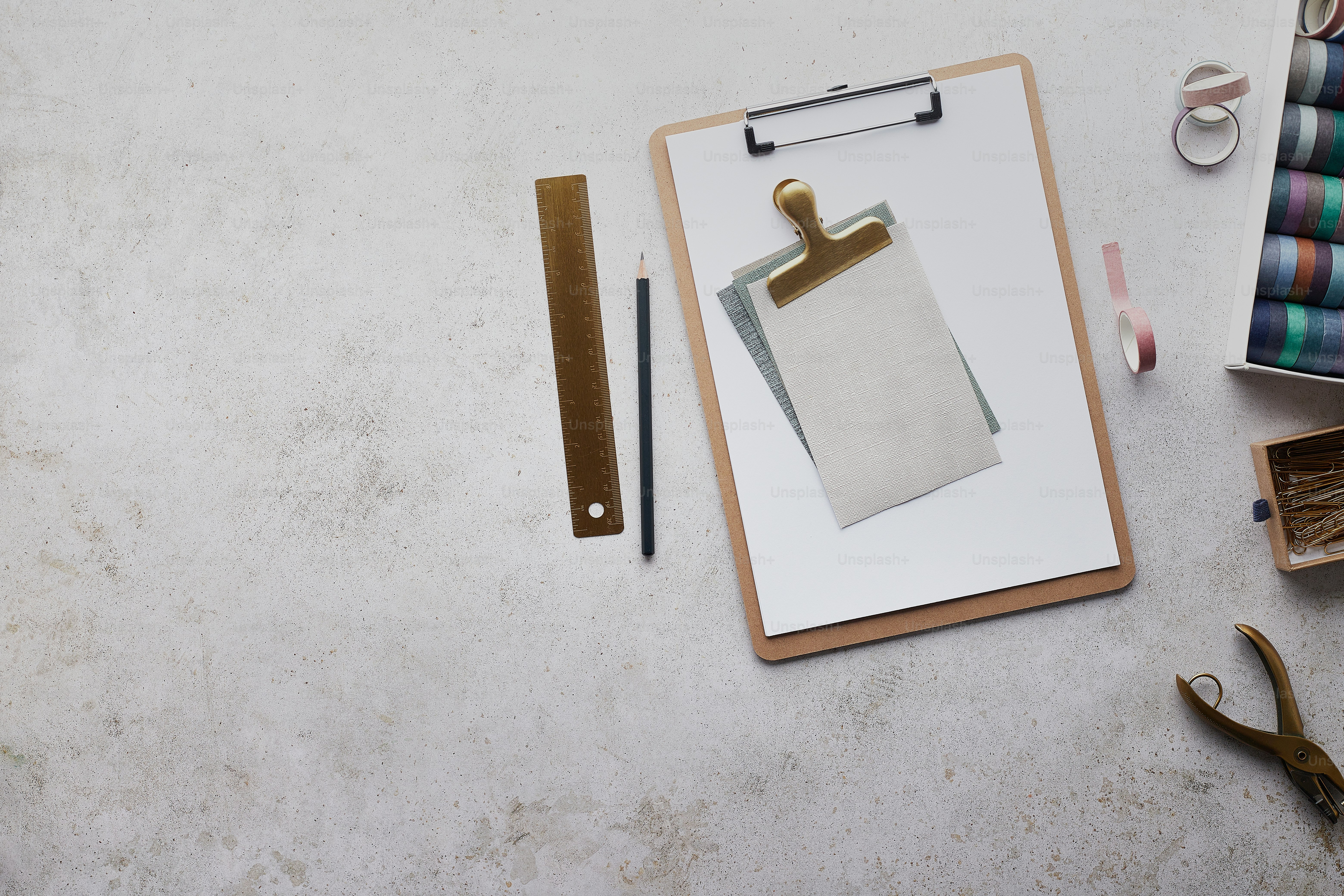 clipboard with ruler and hole punch on desk