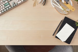 a desk with a keyboard, a mouse, and a notebook