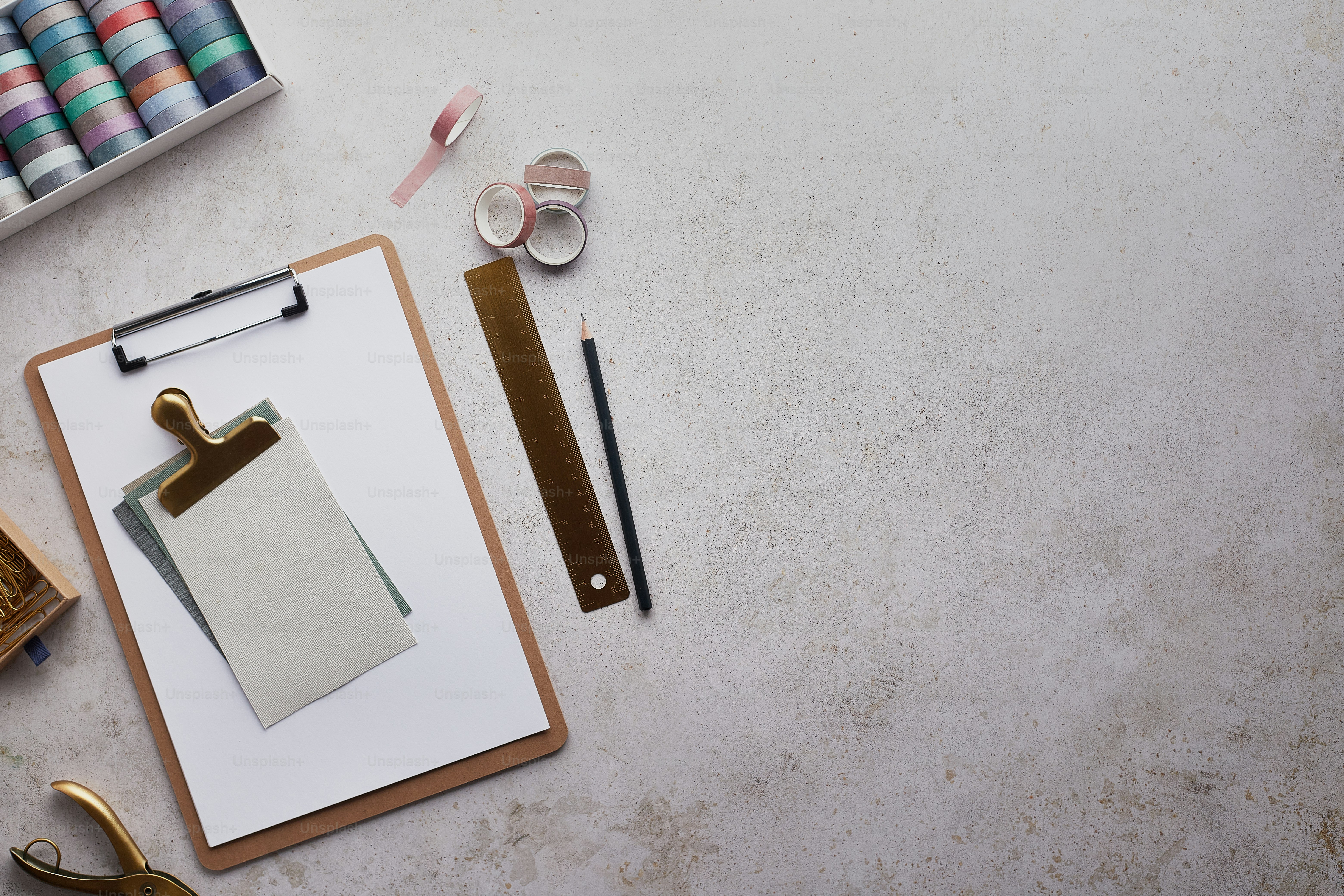 a clipboard with a piece of paper on it next to a pair of scissors