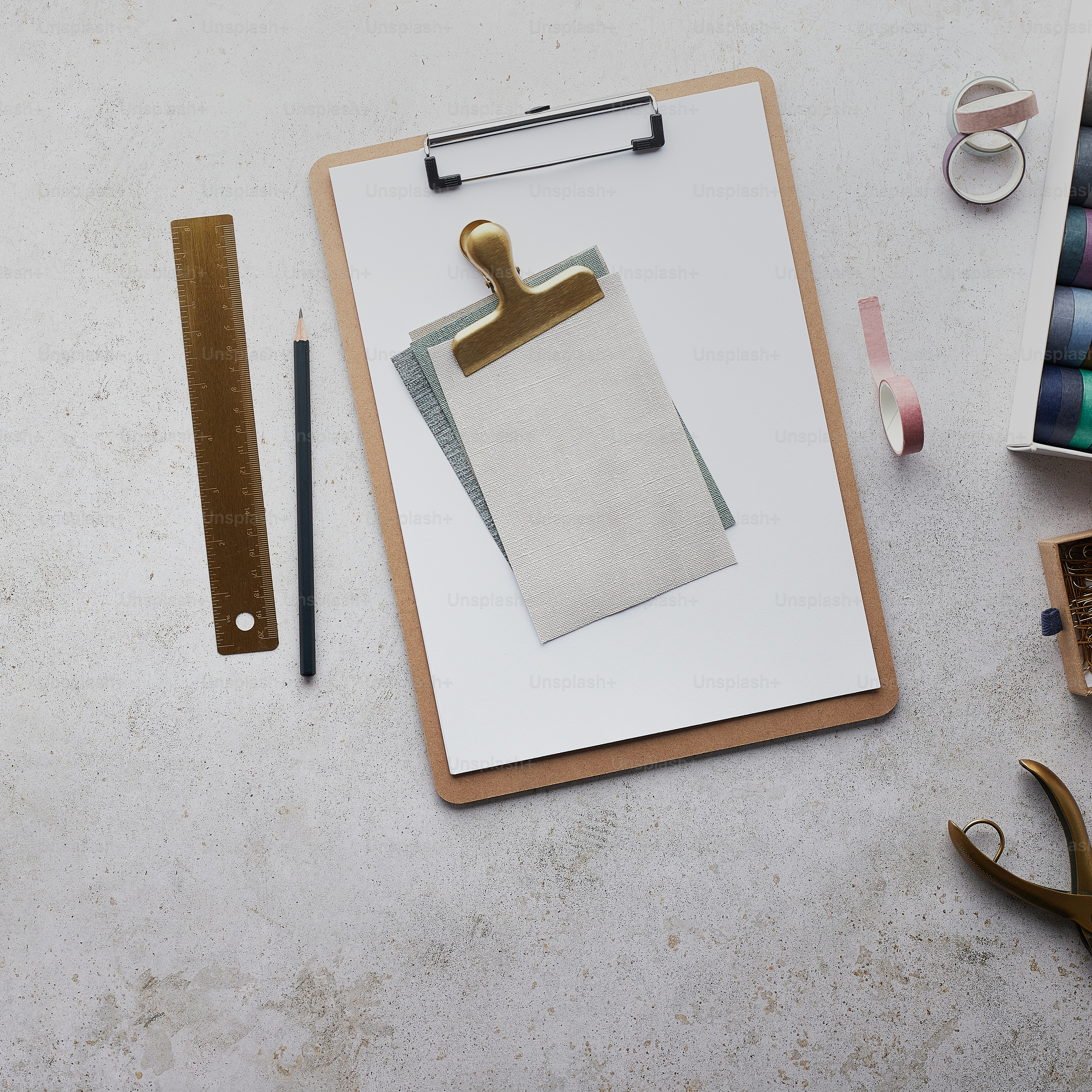 a clipboard with a piece of paper on it next to a pair of scissors