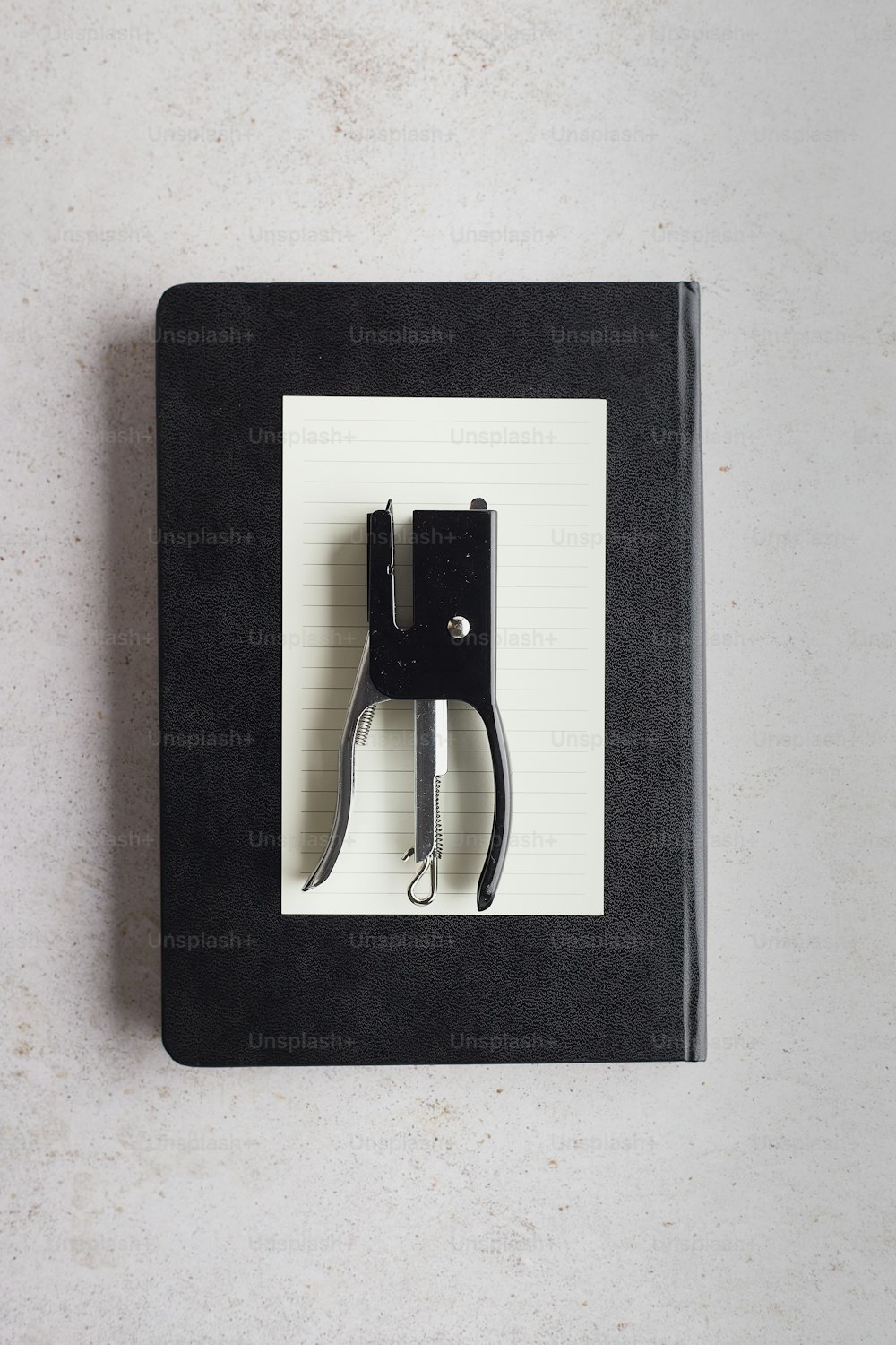 a black binder with a black handle and a black clipboard attached to it