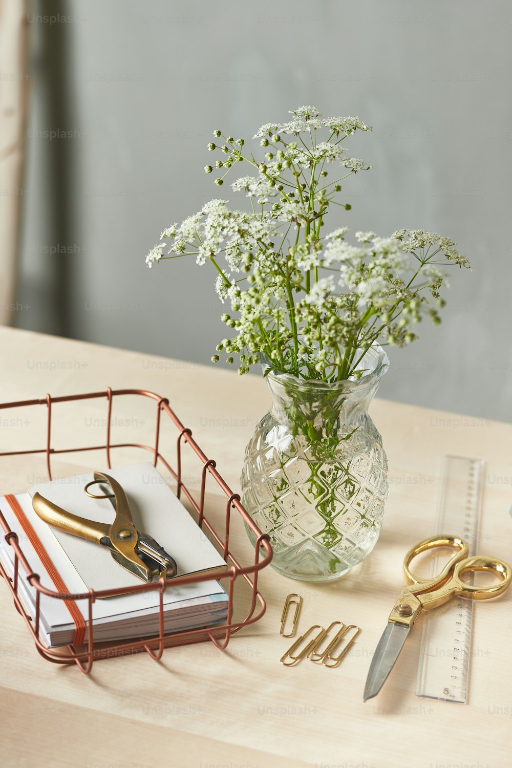 a vase of flowers and a pair of scissors on a table