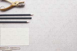 a pair of scissors, pencils, and a notepad on a table