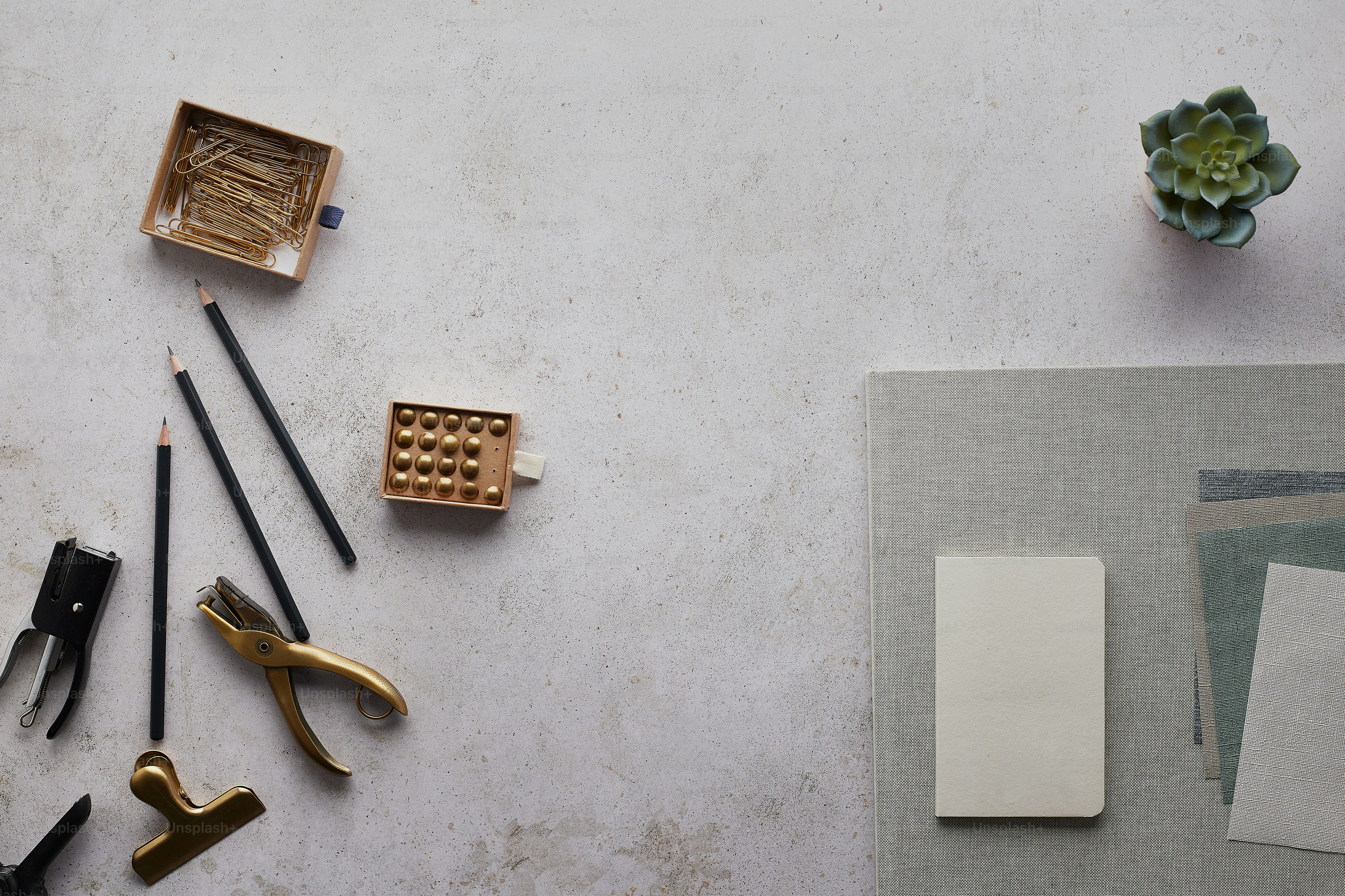 a table topped with lots of office supplies