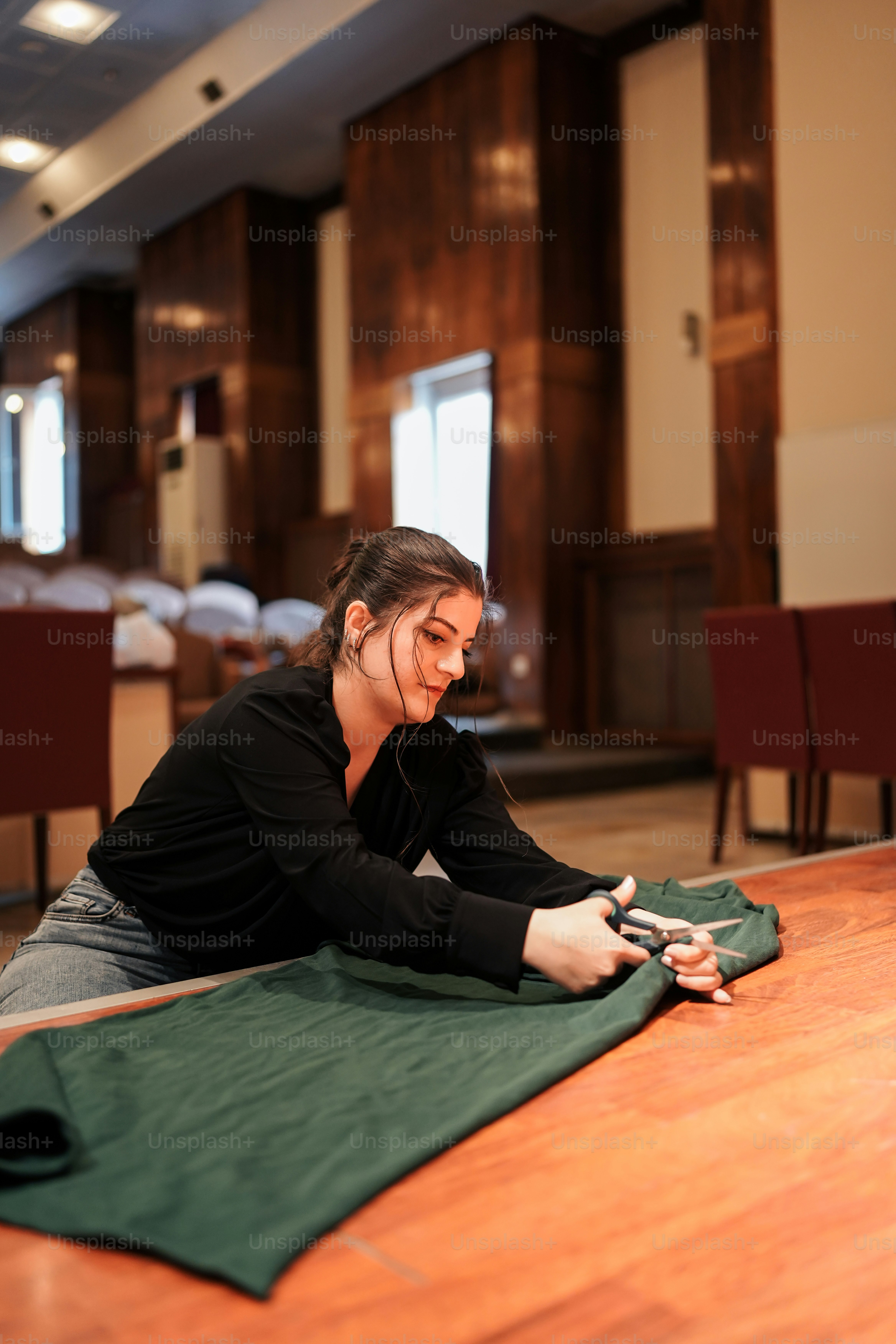 a woman sitting on the floor using a cell phone