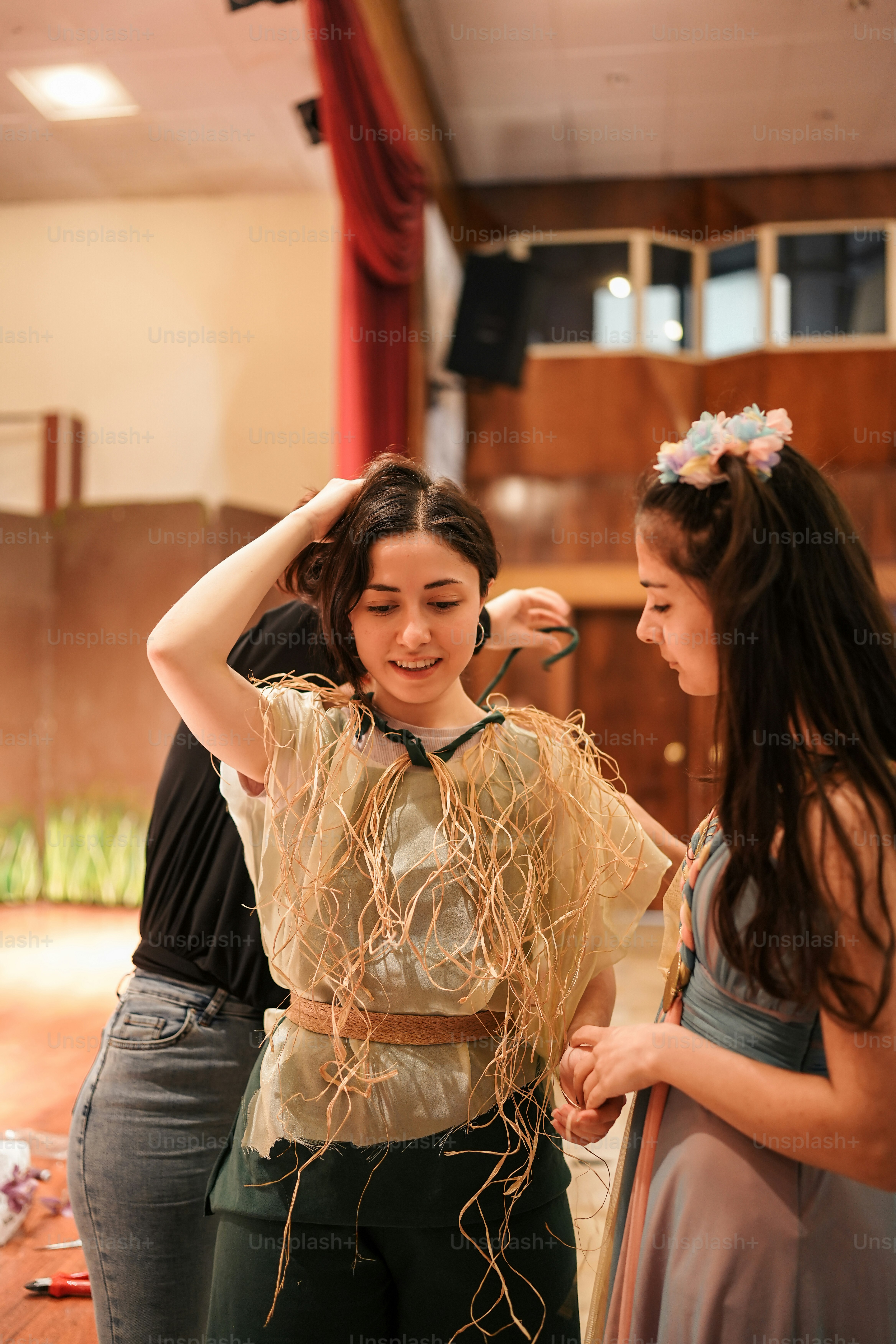 a woman standing next to another woman in a room