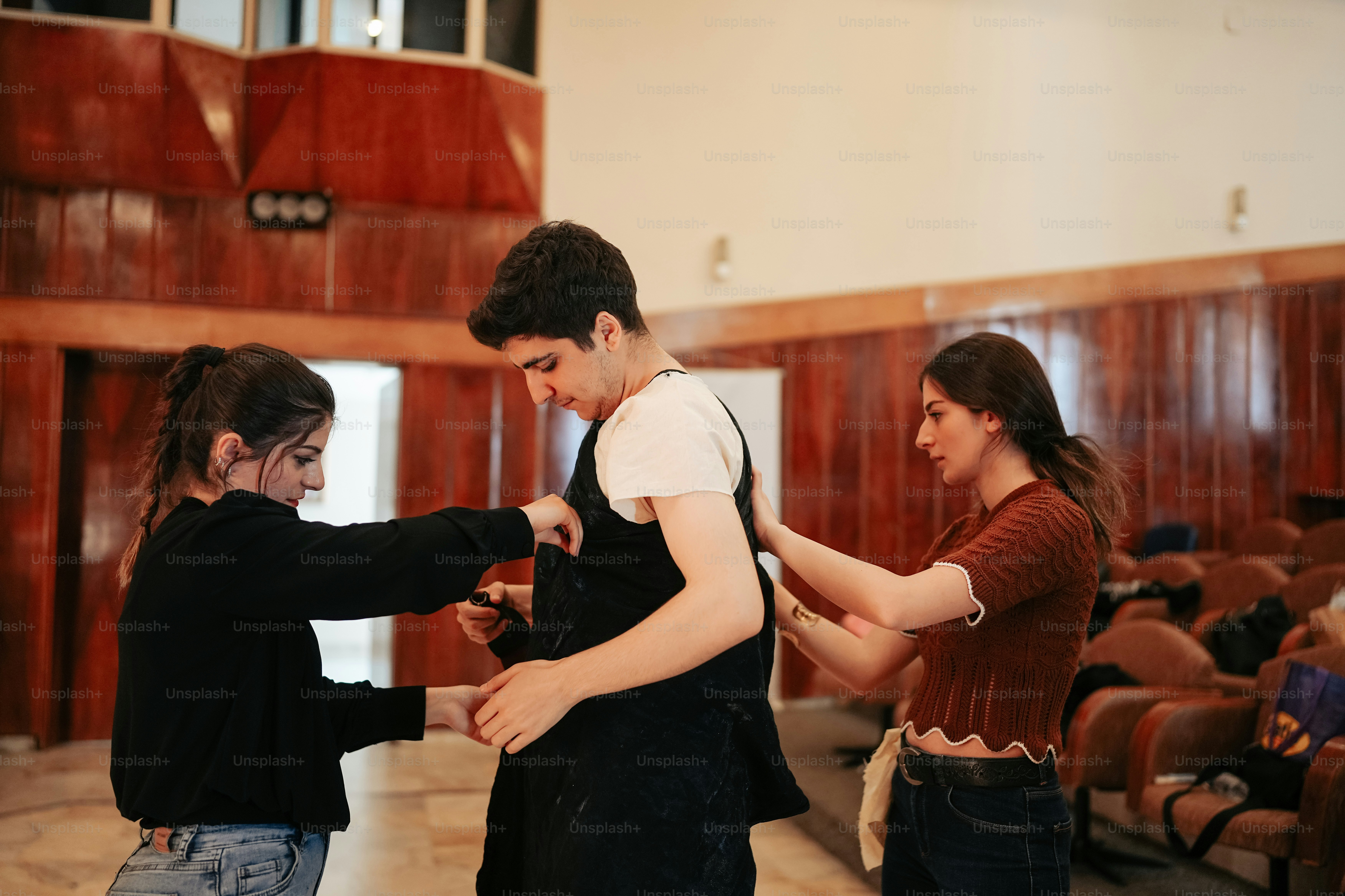 a group of people standing around each other in a room