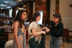 two girls standing next to each other in a room