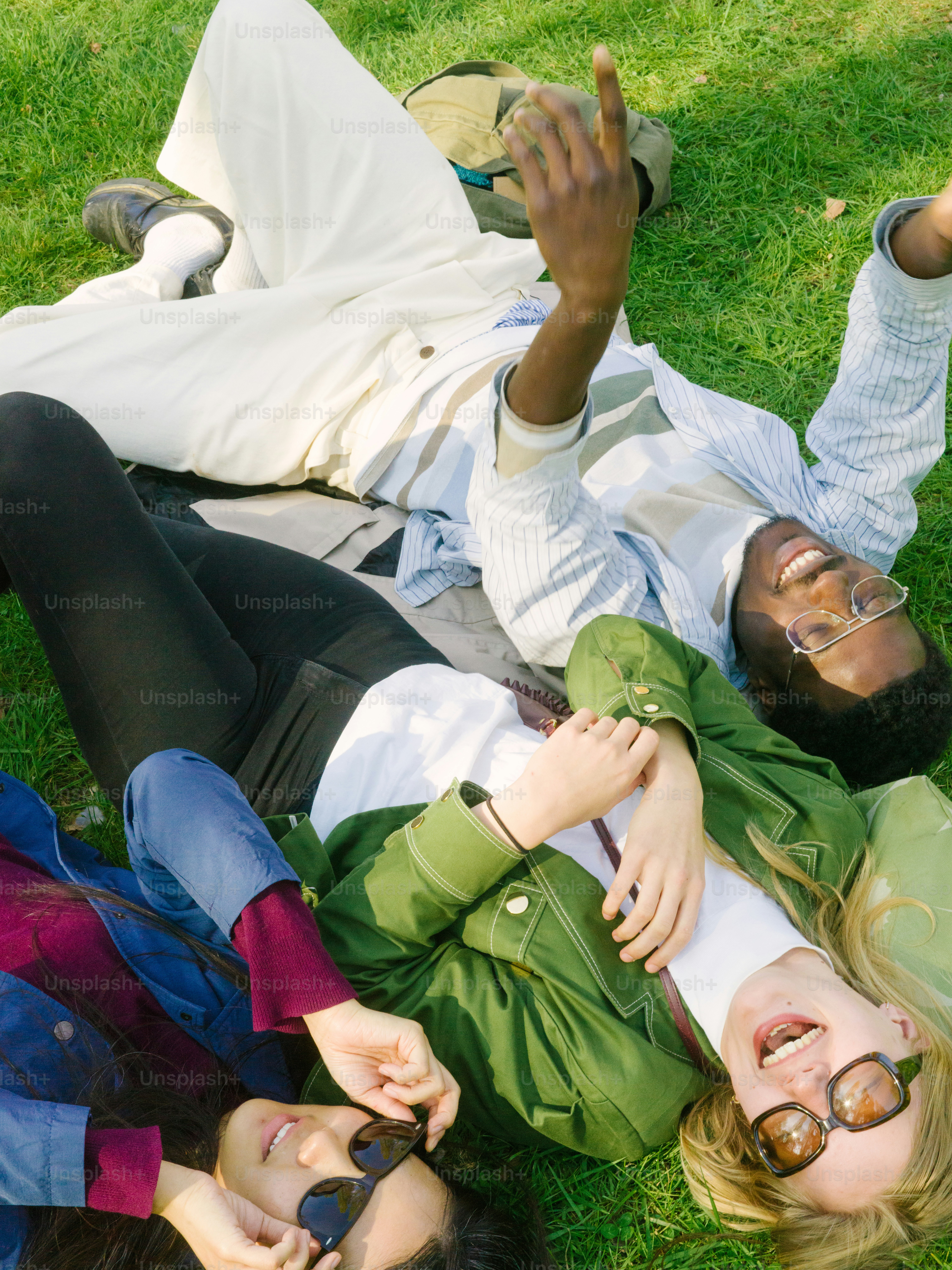 a group of people laying on the grass