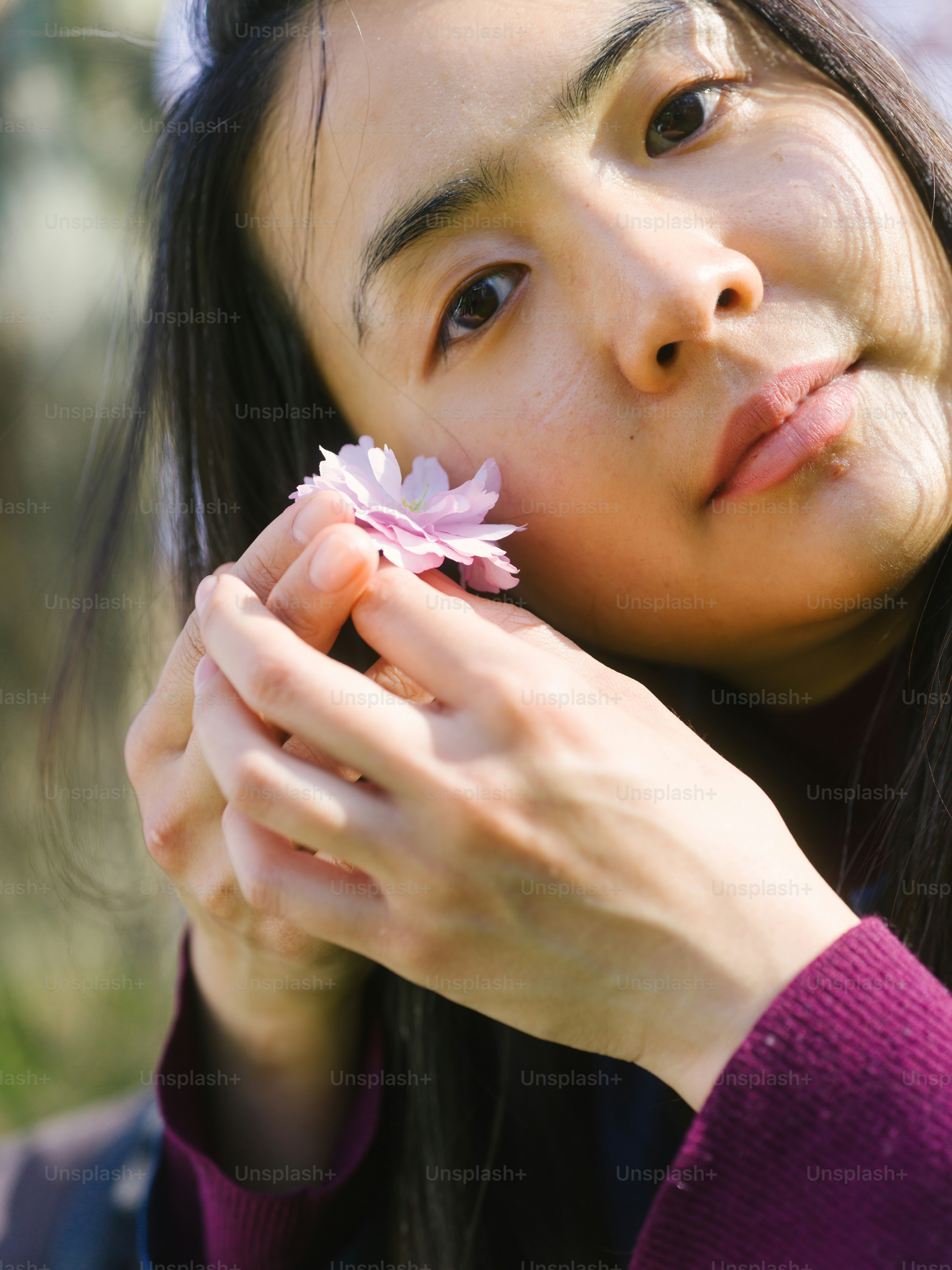 A woman holding a flower in her hand photo – Portrait Image on Unsplash