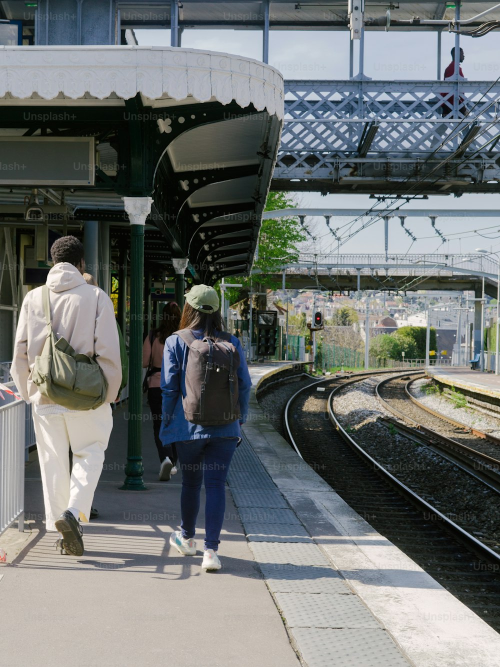 a group of people walking towards a train station