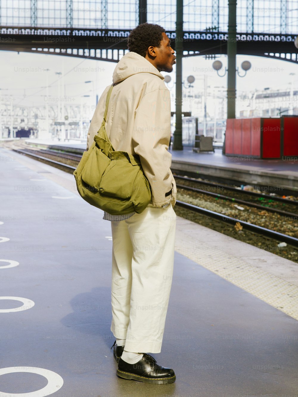 a man with a backpack waiting for a train