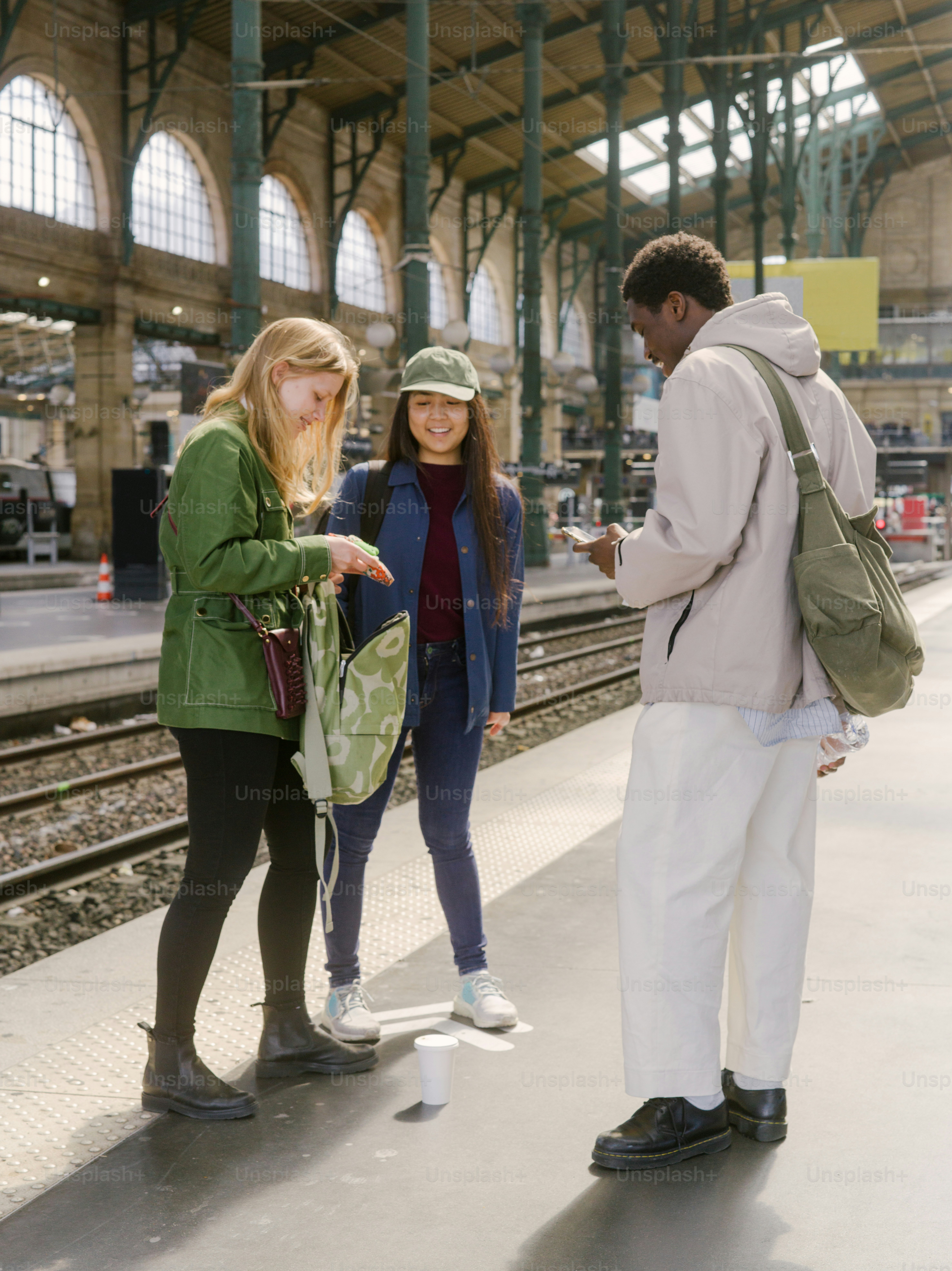 a group of people standing on a train platform