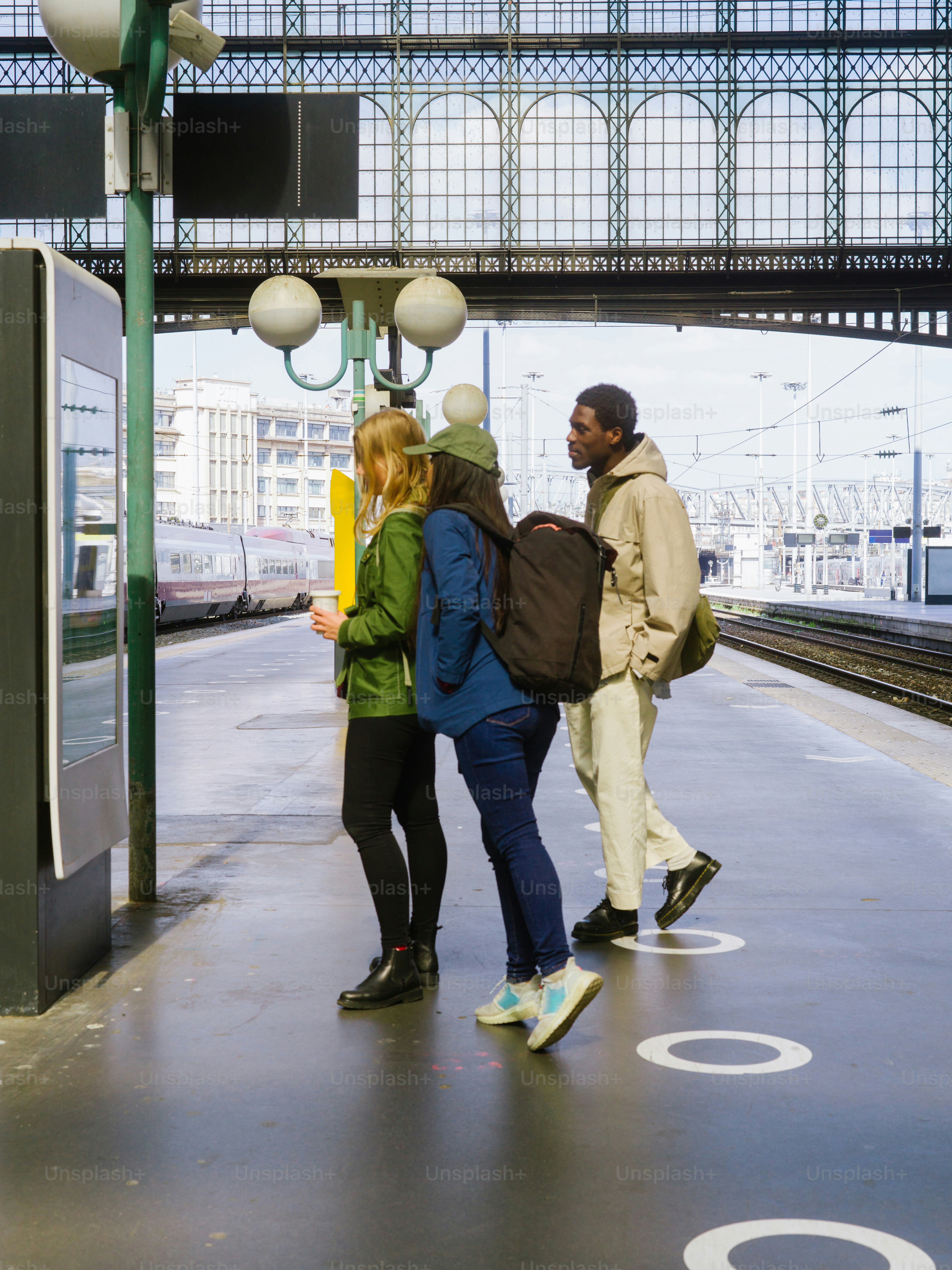 a group of people standing at a train station
