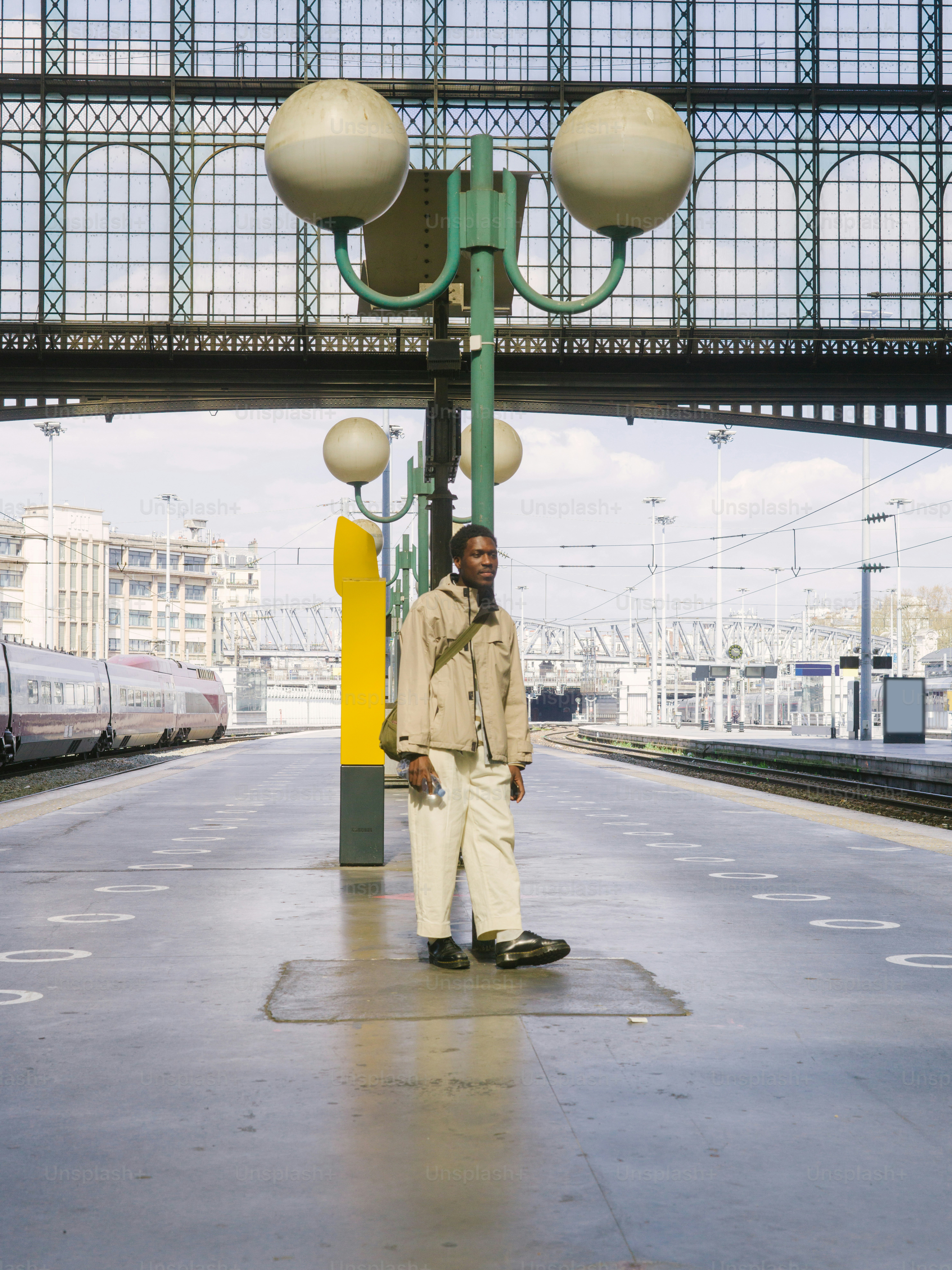 a man standing on a platform next to a train