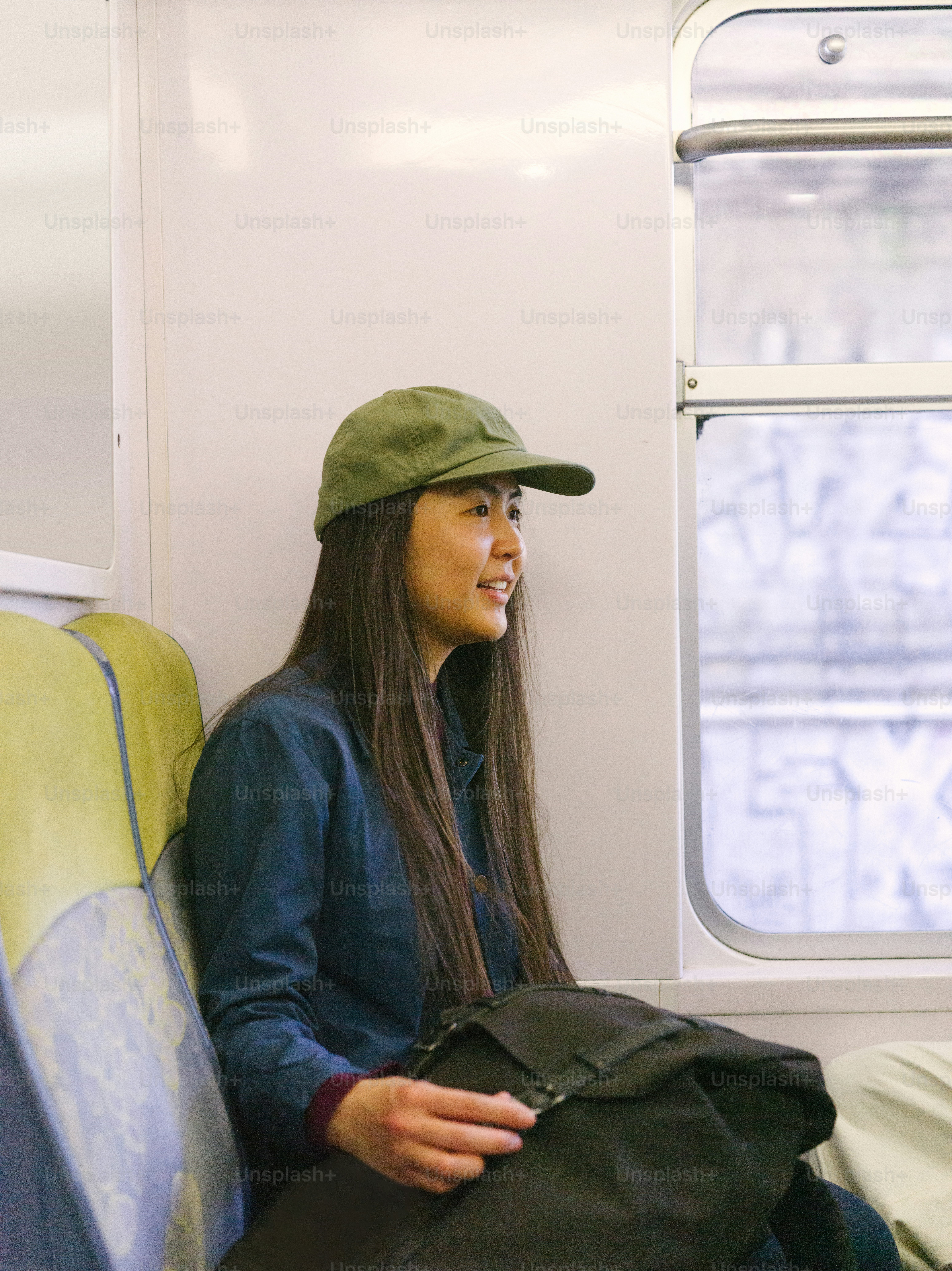 a woman sitting on a train looking out the window