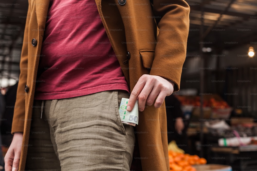 a person wearing a coat and holding a card