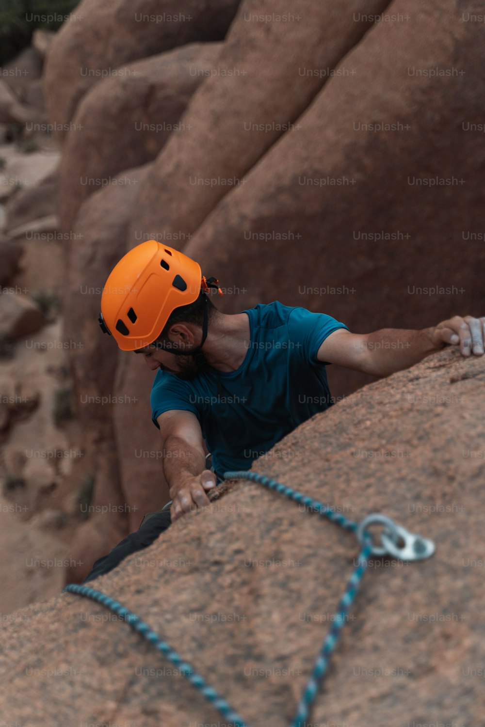 a man climbing up the side of a mountain