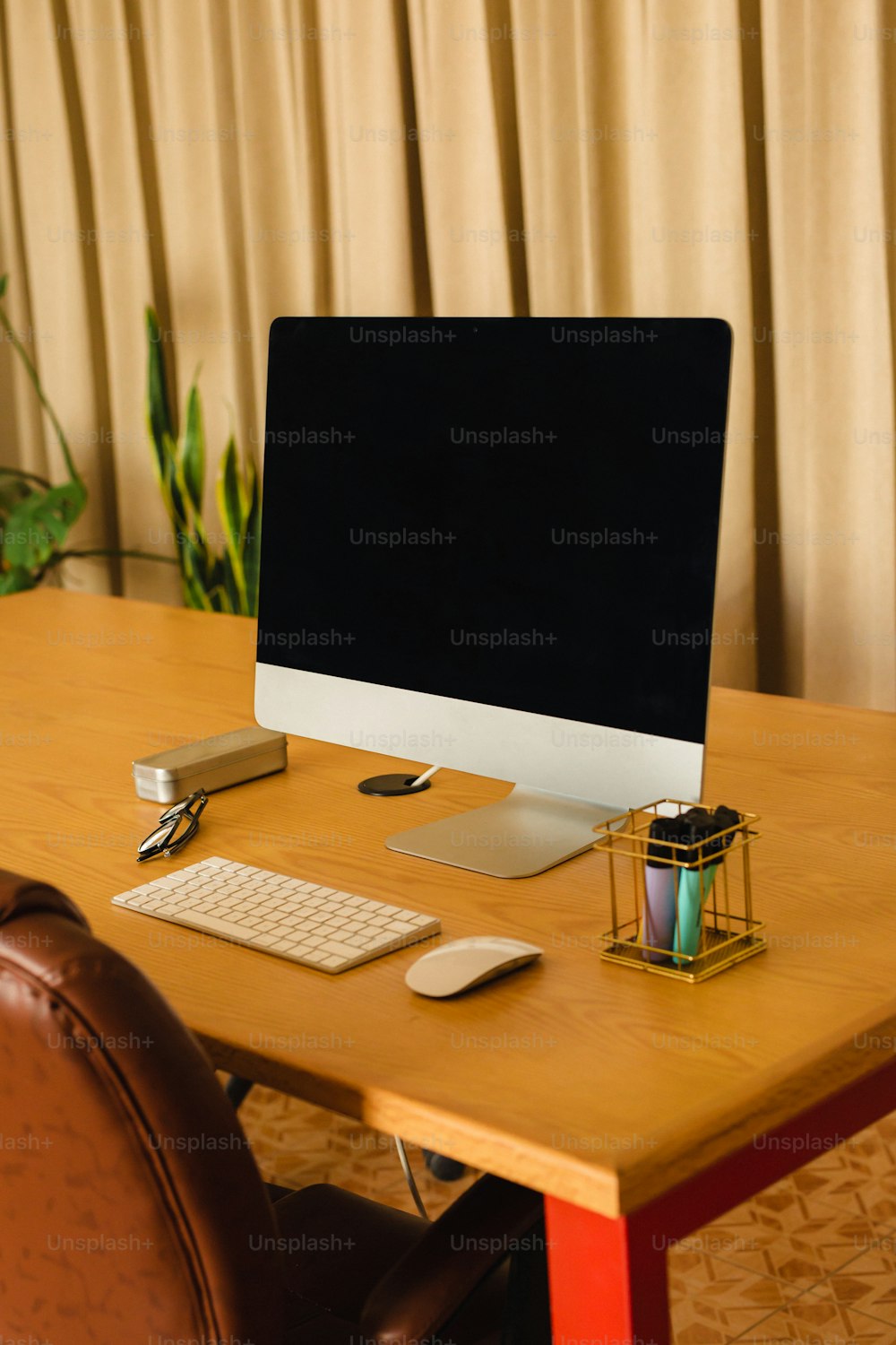 a computer monitor sitting on top of a wooden desk