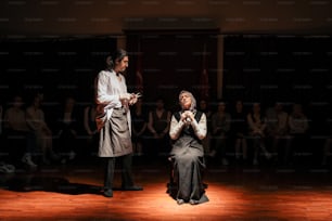 a man and a woman standing on a stage