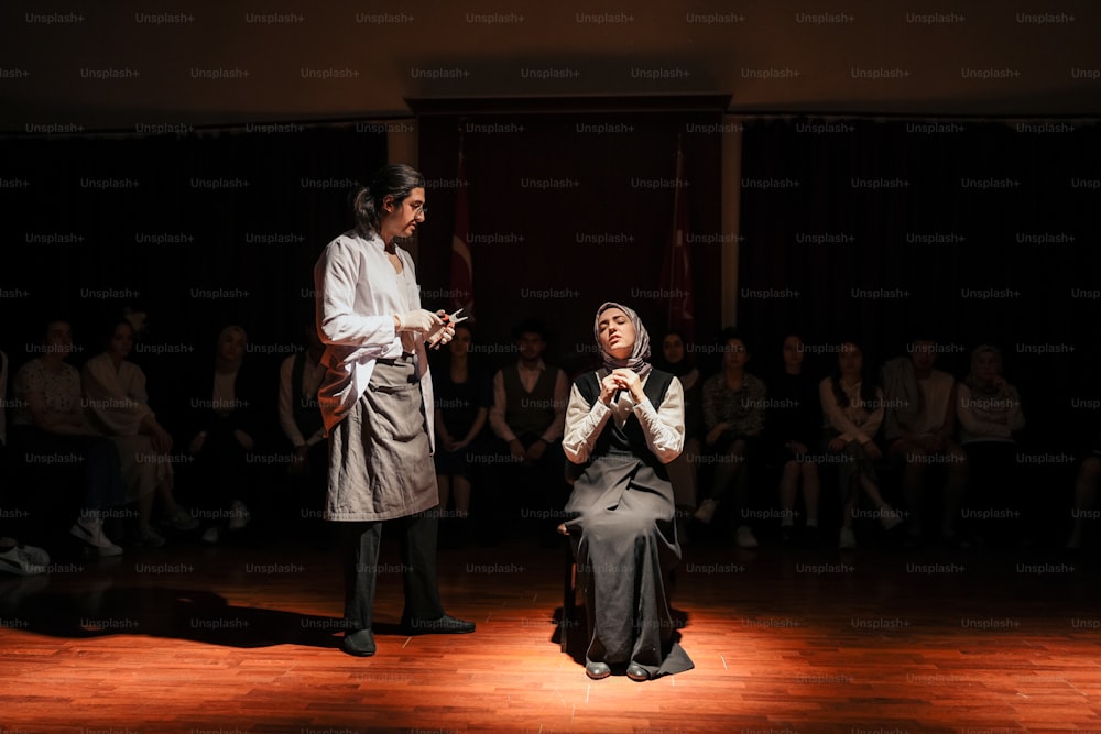 a man and a woman standing on a stage