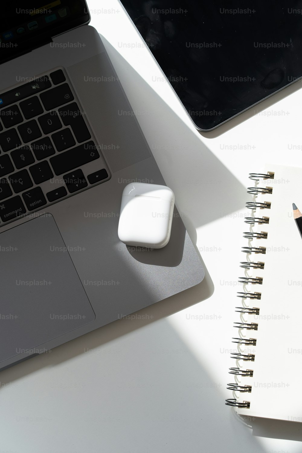 a laptop computer sitting on top of a white desk