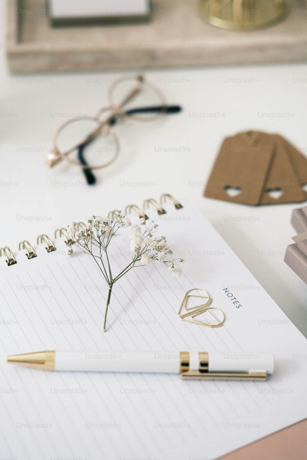 un bloc-notes avec une fleur et un stylo dessus